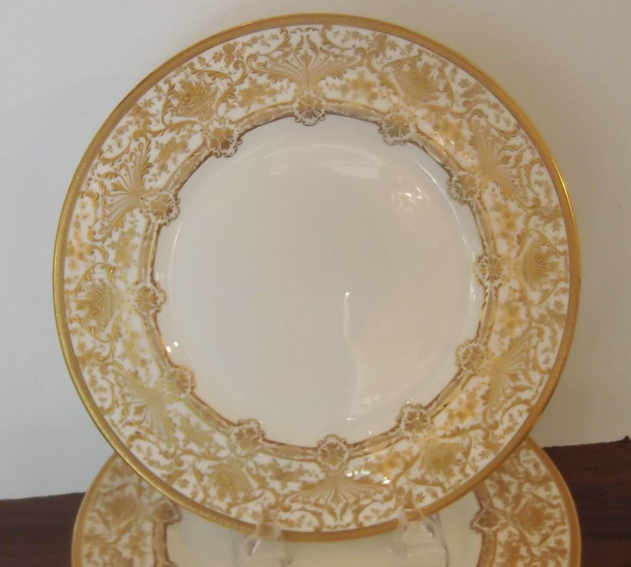 Elegant and classic gold set of 12 encrusted English service plates.
The raised gilt borders are done by the master decorator Herbert Betteley for Royal Doulton, Year mark 1902.
This particular mark was introduced in the latter part of 1901 to