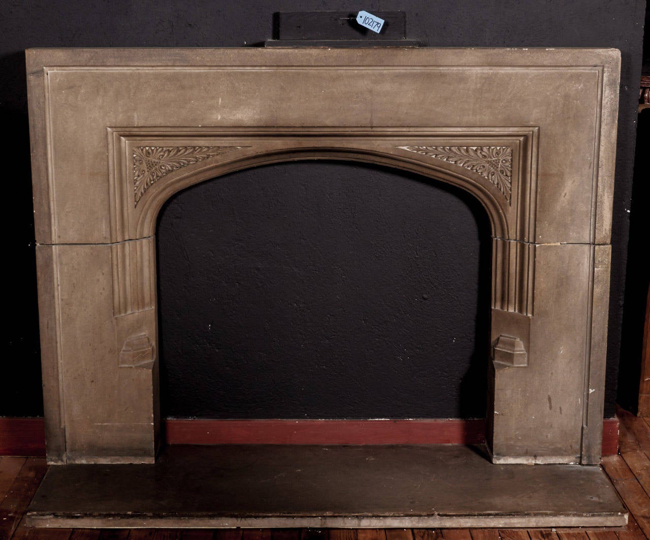 Large flush mounted antique Tudor style carved Limestone fireplace mantel having stop-chamfered jambs, unadorned frieze and carved spandrels with foliate motifs. Provenance: Upper East Side Townhouse, NY designed by McKim, Meade & White. Opening 42