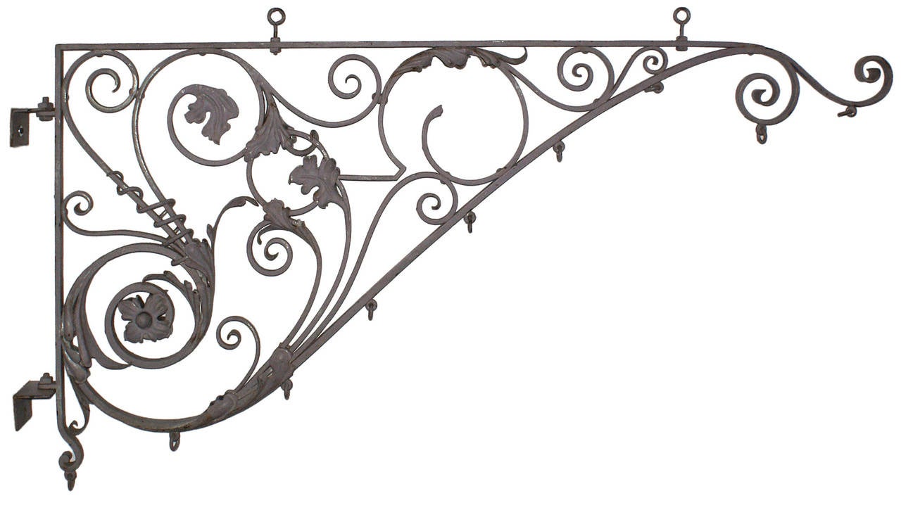 Elegant and large-scale late 19th century painted wrought iron sign bracket having intricate tendril, like scrolled metalwork with floral and foliate motifs.