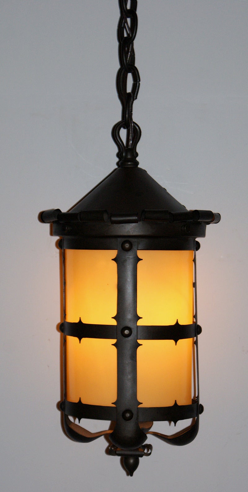 First quarter of the 20th century Arts and Crafts style pendant lantern having custard glass interior shade. The lantern measures 18.25