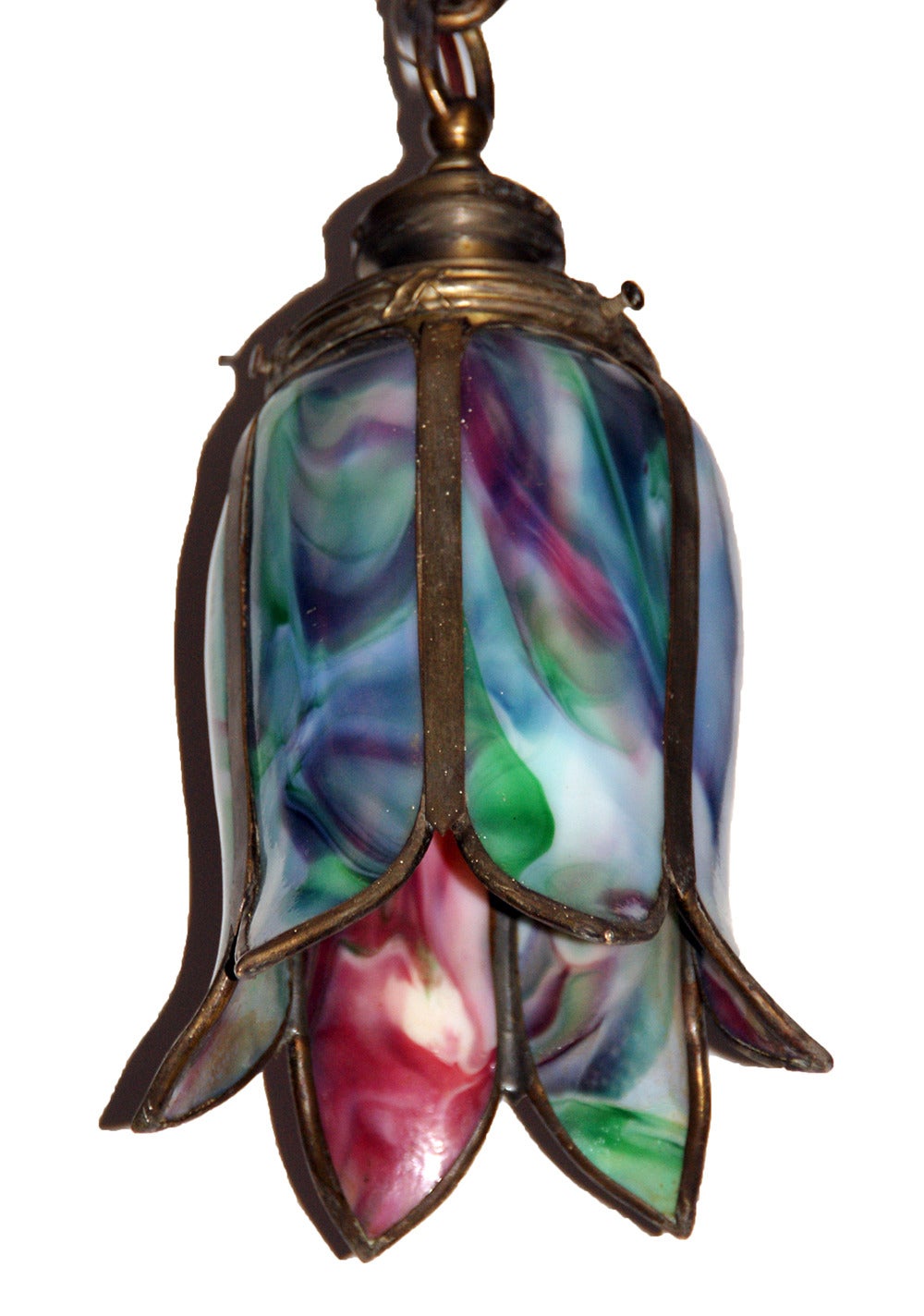 Beautiful early 20th century pendant fixtures attributed to ‘Bradley & Hubbard’ having richly colored slag, opalescent glass tulip form shades and ribbon and reed fitters. The finish is original, and shows some minor wear, normal and consistent with