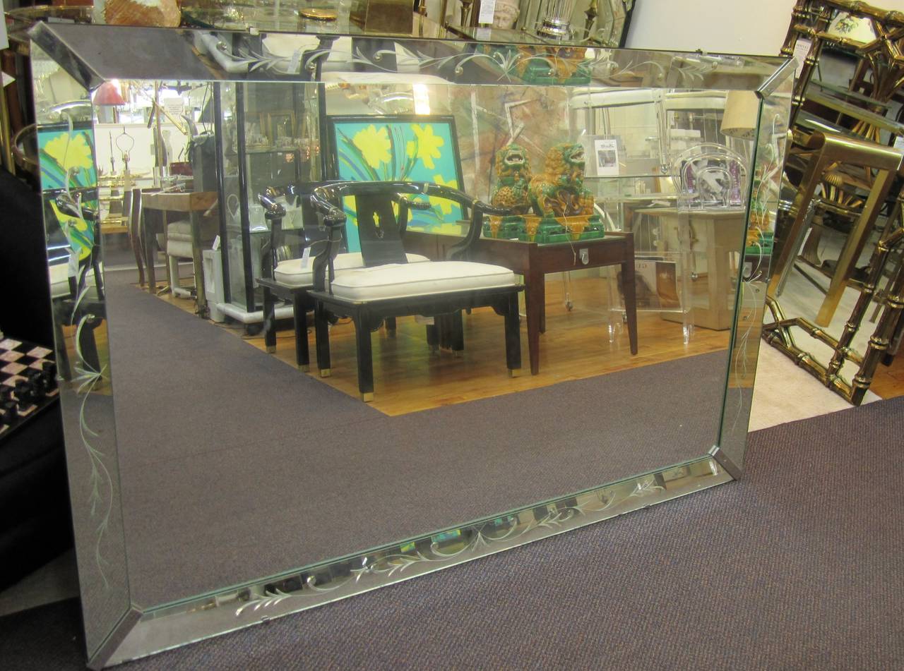 A beautiful and relatively large Italian wall mirror, circa mid-20th century, 1940s - 1950s, Italy. This rectangular mirror has chrome corner detail and etched design on its mirrored glass frame. Mirror can hang horizontally or vertically. Mirror is