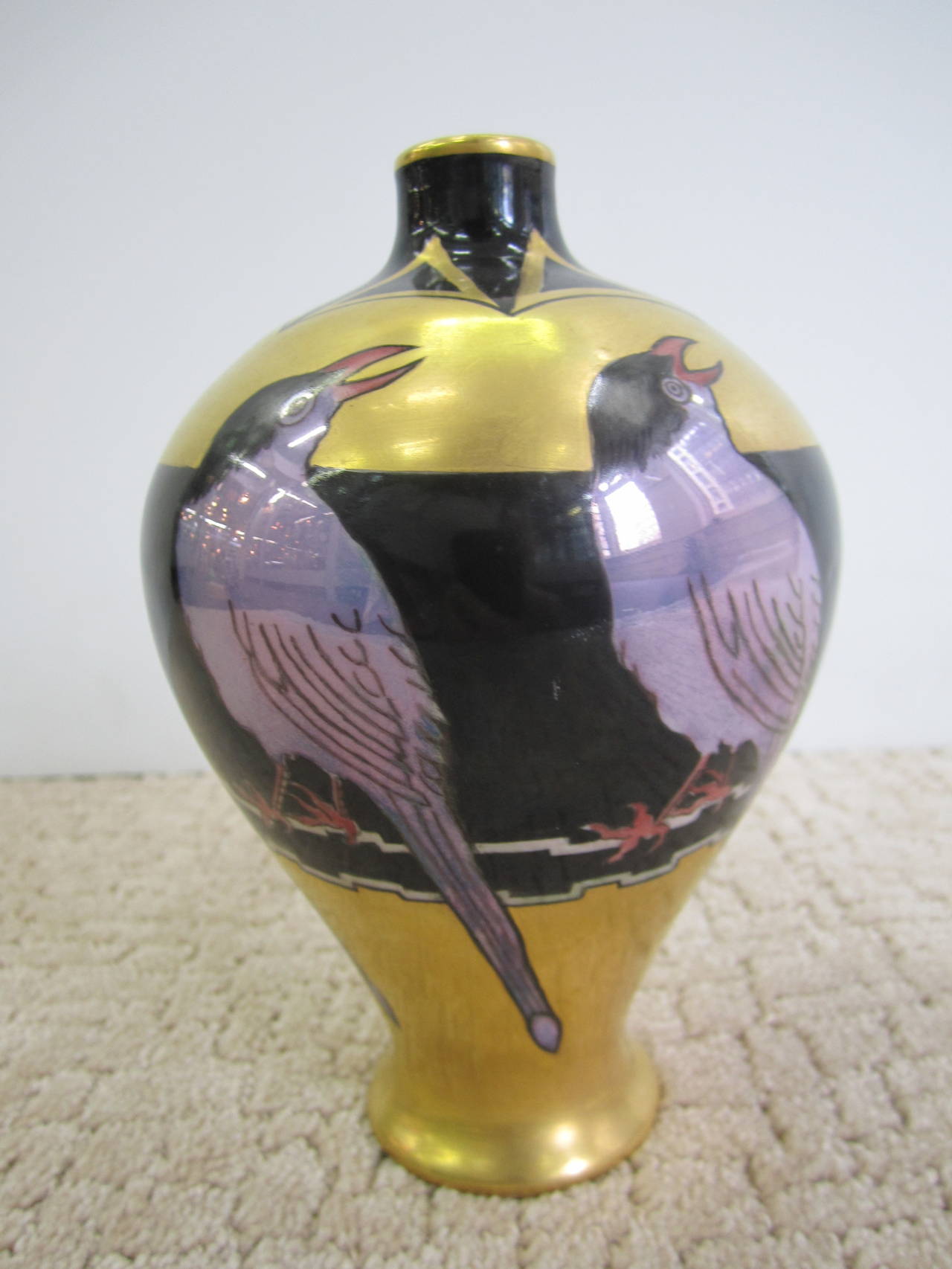 A beautiful French Art Deco black and gold hand-painted Limoges porcelain vase with bird design. Other hand-painted colors include: purple and red on the bird's feet. From France, circa 1930s.

Item available here online. By request, item can be