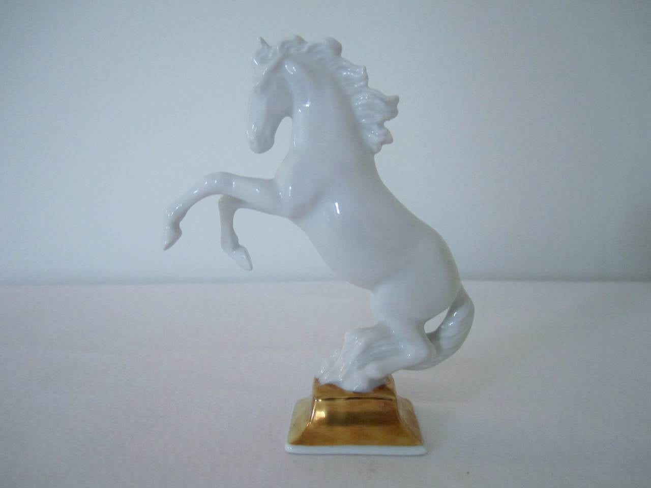 A vintage blanc-de-chine porcelain Horse Sculpture by artist Max Hermann Fritz for Rosenthal, Germany, with 24-Karat gold hand-painted base detail.
Sculpted by M H Fritz (name impressed in the base with model number 1027/7 and Rosenthal marking.)