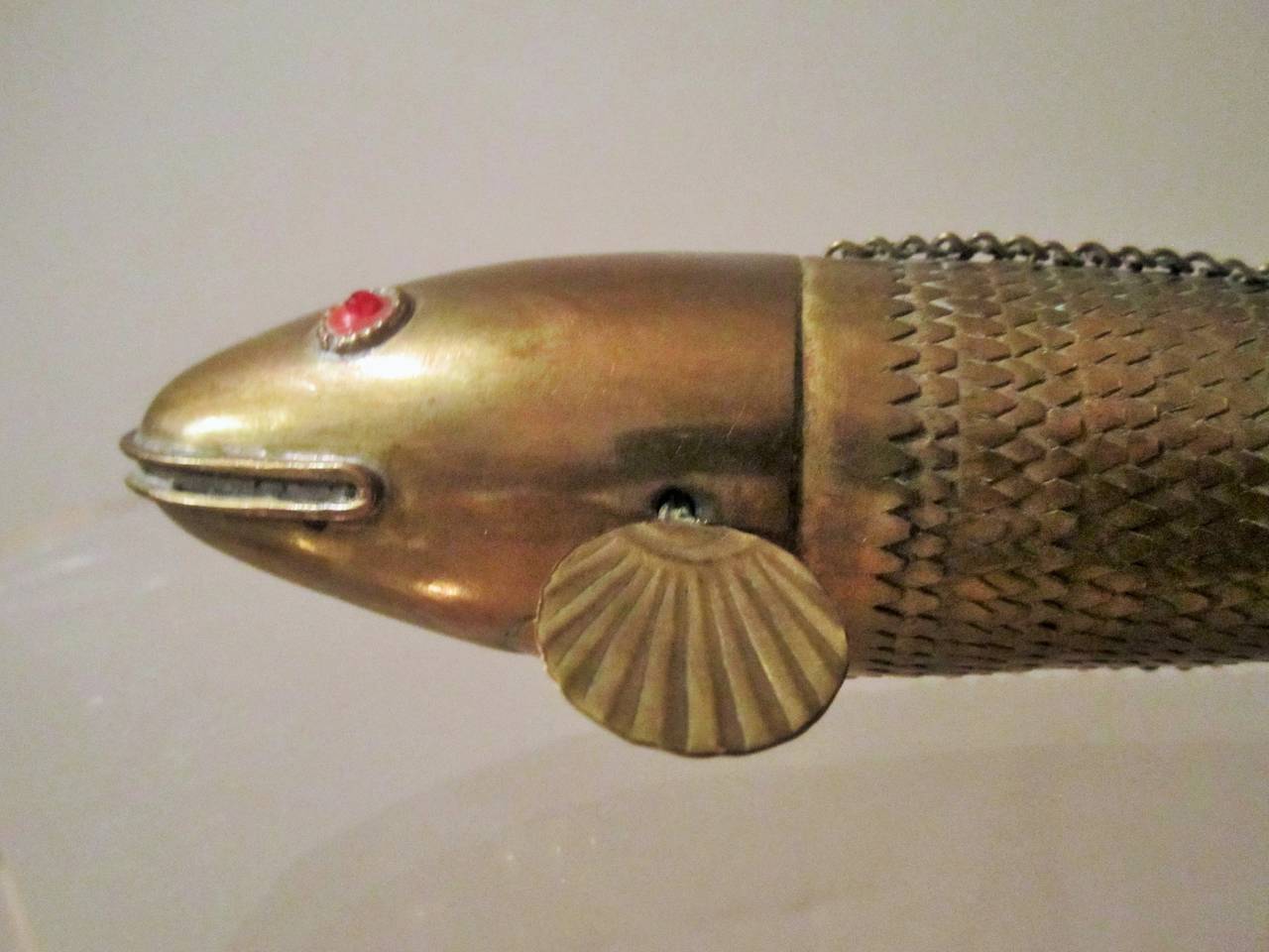 A unique vintage Mid-Century Japanese articulating or kinetic brass koi fish sculpture with ruby-like red eyes. Measures 10.5