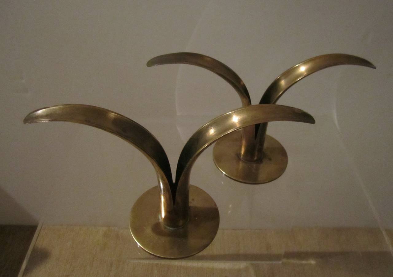 A pair of Scandinavian Modern Swedish Brass Candlestick Holders by Ystad-Metall. With Makers Mark on bottom as seen in image. AKA the 'Lily' candlestick holder. Designer is Ivar Alenius Bjork. Manufacturer: Ystad Metall. Period/Style: Swedish
