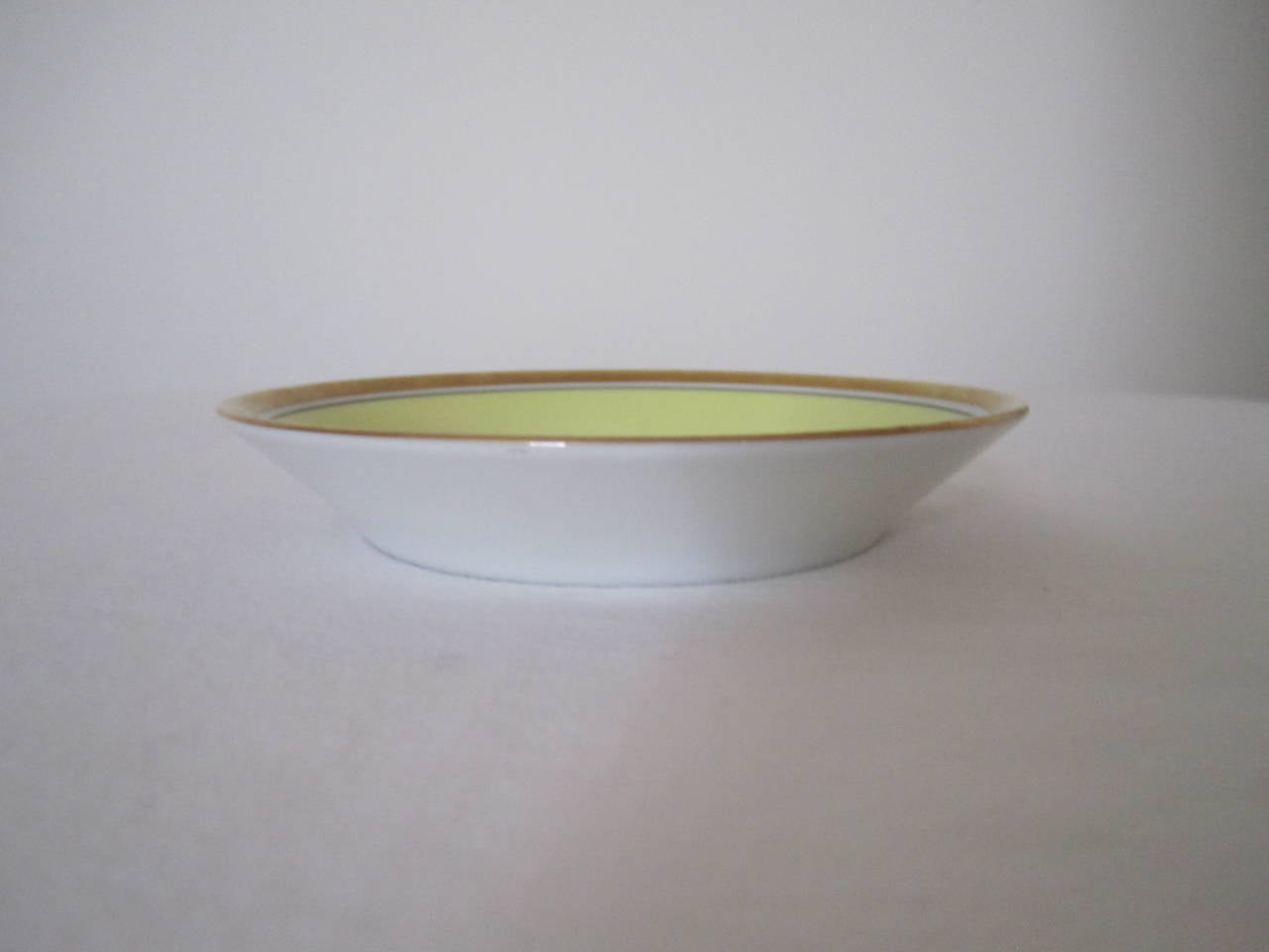 Mid-Century Italian dish or plate by desinger Richard Ginori with decorative urn detail. Colors include yellow, gold, white and black. With maker's mark on back as show in image #3. This small dish or plate can serve as a nice piece to hold jewelry