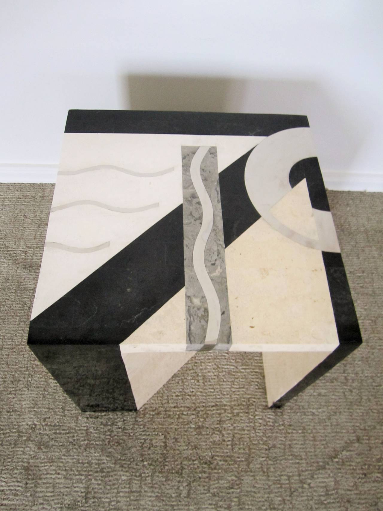 Stunning Post-Modern Italian tessellated marble side or end table by Oggetti. Table has a sculptural form with unexpected diagonal leg opening the cube on two sides. Table includes maker's mark, Tavola by Oggetti, underneath as show in image #8.