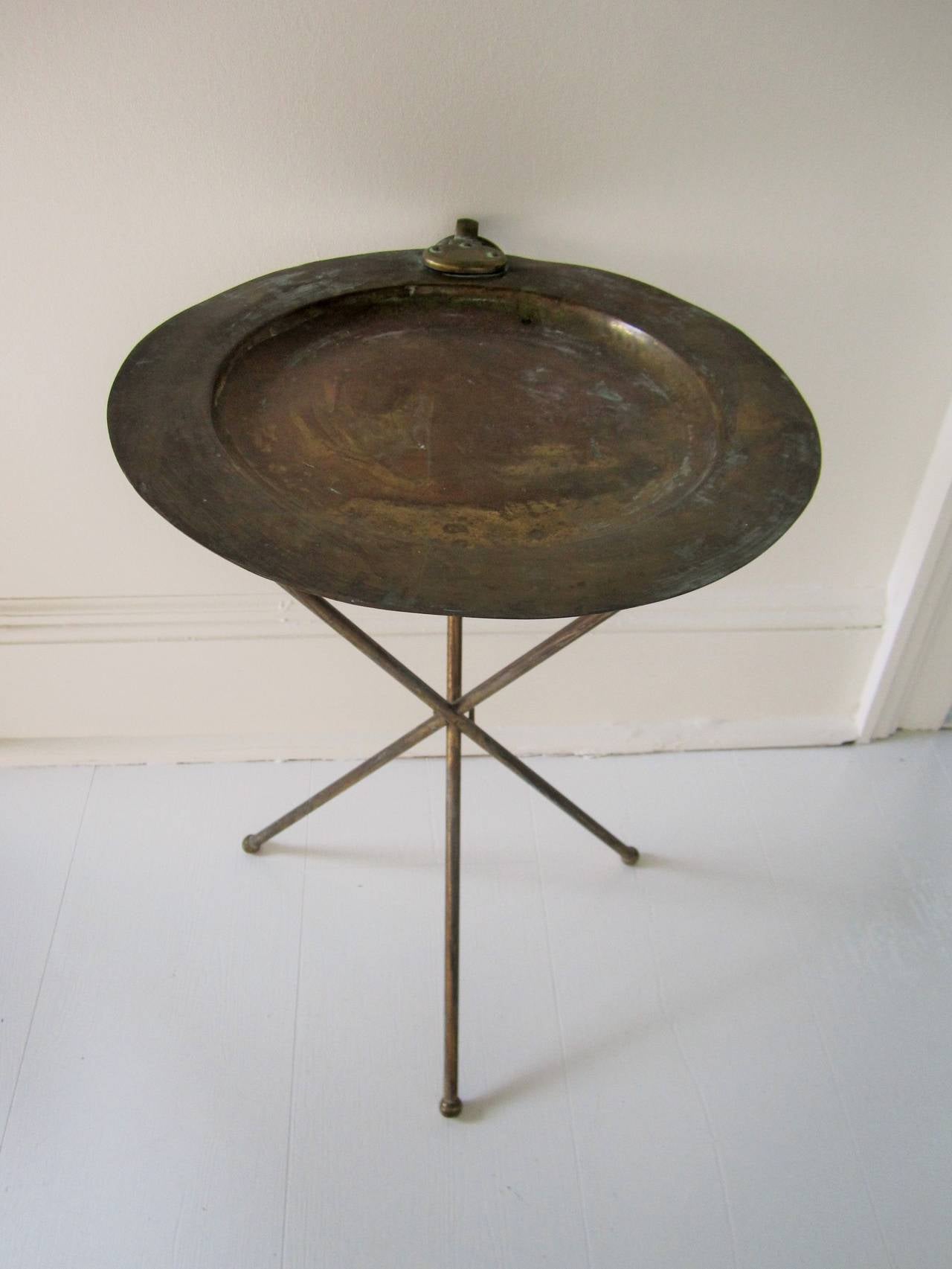 A chic vintage Italian brass folding tripod side table with 'ring' detail in the style of Valenti. Item available here online. By request, item can be made available by appointment to the Trade (in New York.) 
 