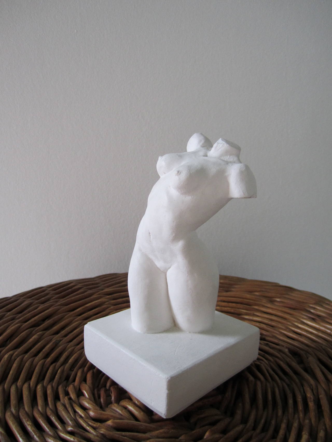A small vintage female nude torso sculpture bust or torso in white plaster. 

Measures 6.25