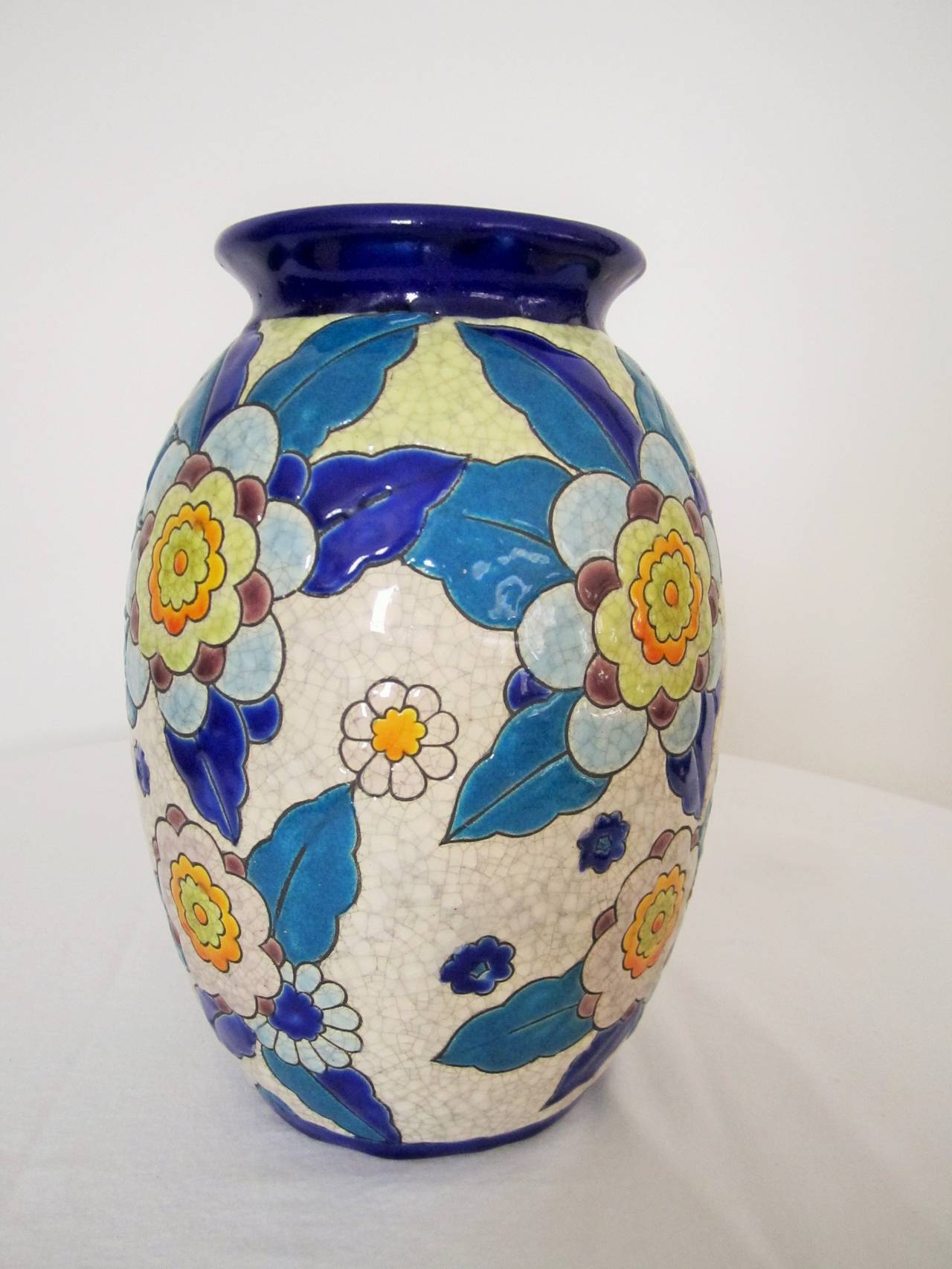 Beautiful vintage colorful floral hand-painted pottery vase in the style of Boch Freres Keramis, Belgium, circa mid-20th Century. 

Vase is 9.5 in. H

Item available here online. By request, item can be made available by appointment to the Trade in