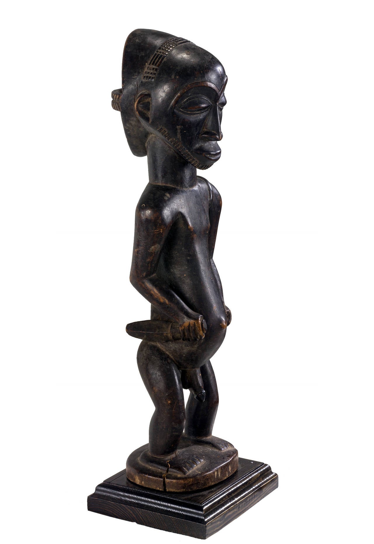 Important Hemba male hunter from congo, holding a knife and shield on his hands while carrying arrows at her back with, beautiful black patina wearing a well-made coiffure which is open at the back. Traditionally these pieces were created for the