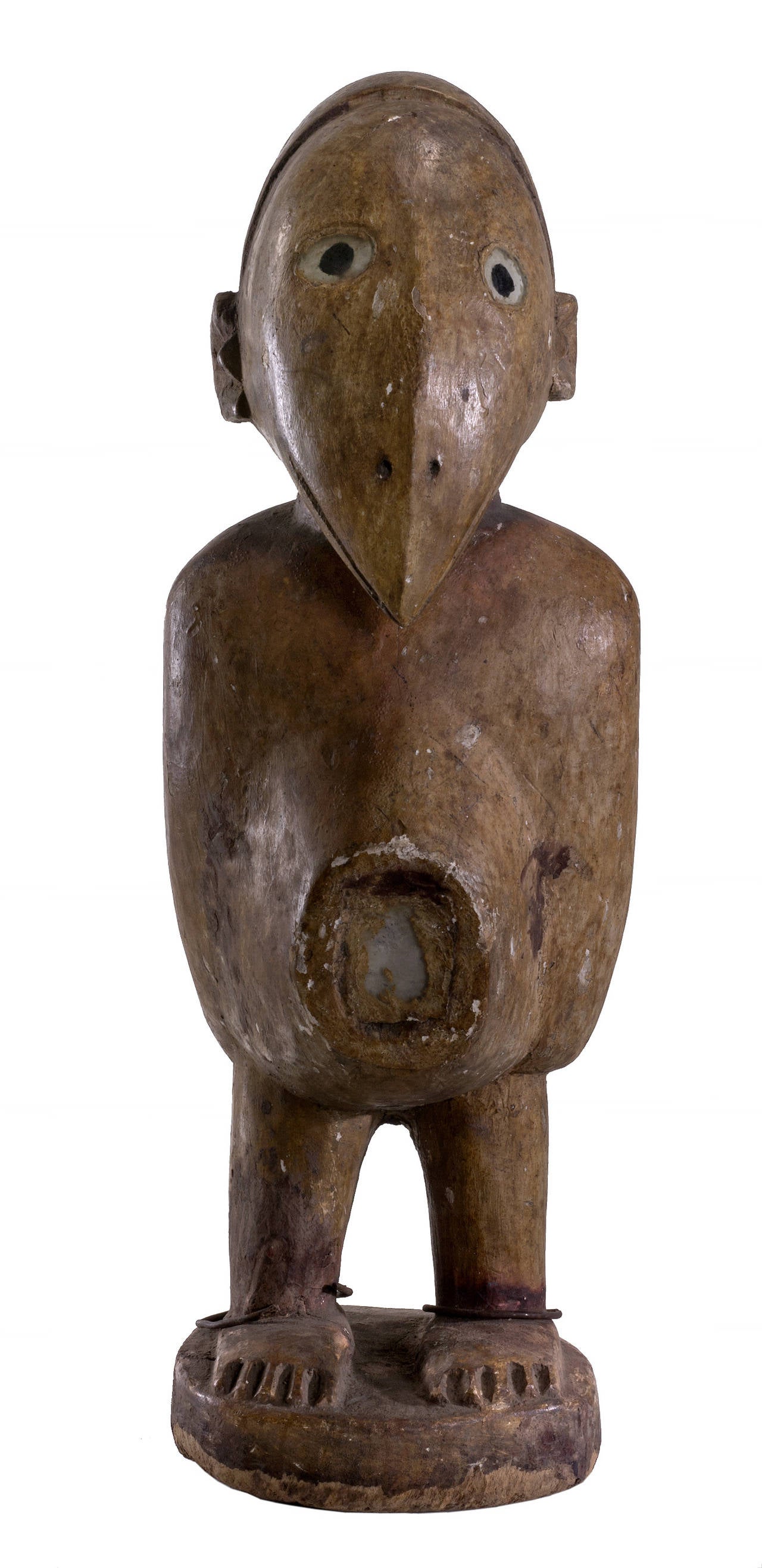 Power figure 20th century from the Congo. Made from wood, and painted yellow on top.Its one of few Congo pieces with prolonged face of an owl and human combined which indicate awareness and protection. There is a mirror in the belly with protective
