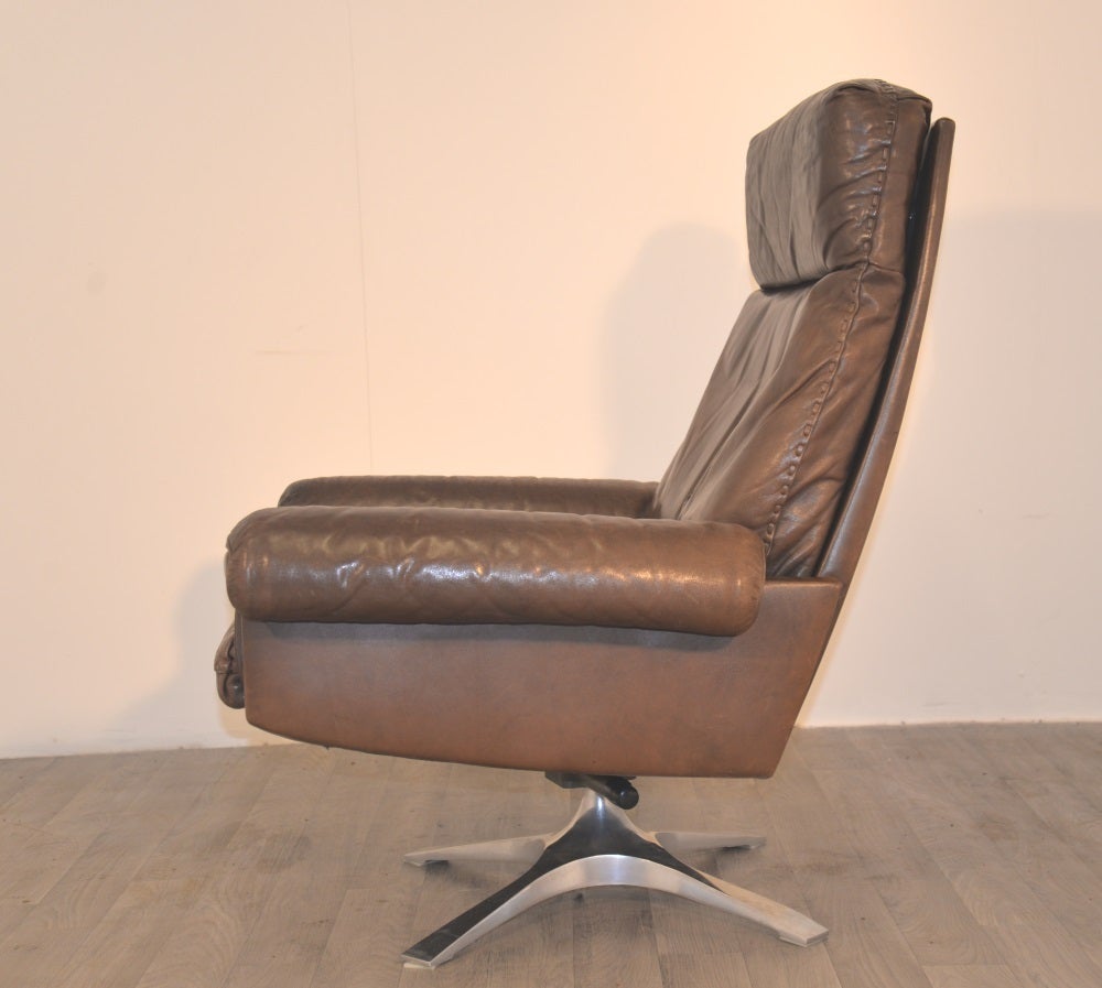 Vintage 1970s De Sede high-back lounge armchair in soft chocolate brown leather with superb whipstitch edge detail. This high-back lounge armchair was built circa 1970s by De Sede craftsman in Switzerland. The lounge swivel armchair is in very good