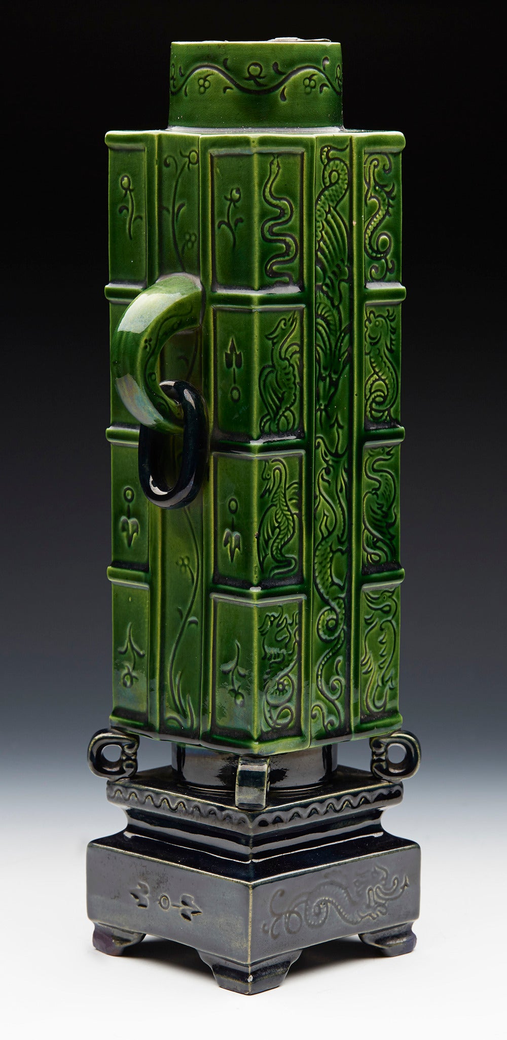 A rare Arts & Crafts twin handled vase designed by Christopher Dresser for W Brownfield incised with dragons, snakes and other grotesque creatures and with loop and ring handles and with an original metal lift out liner. Please see Christopher