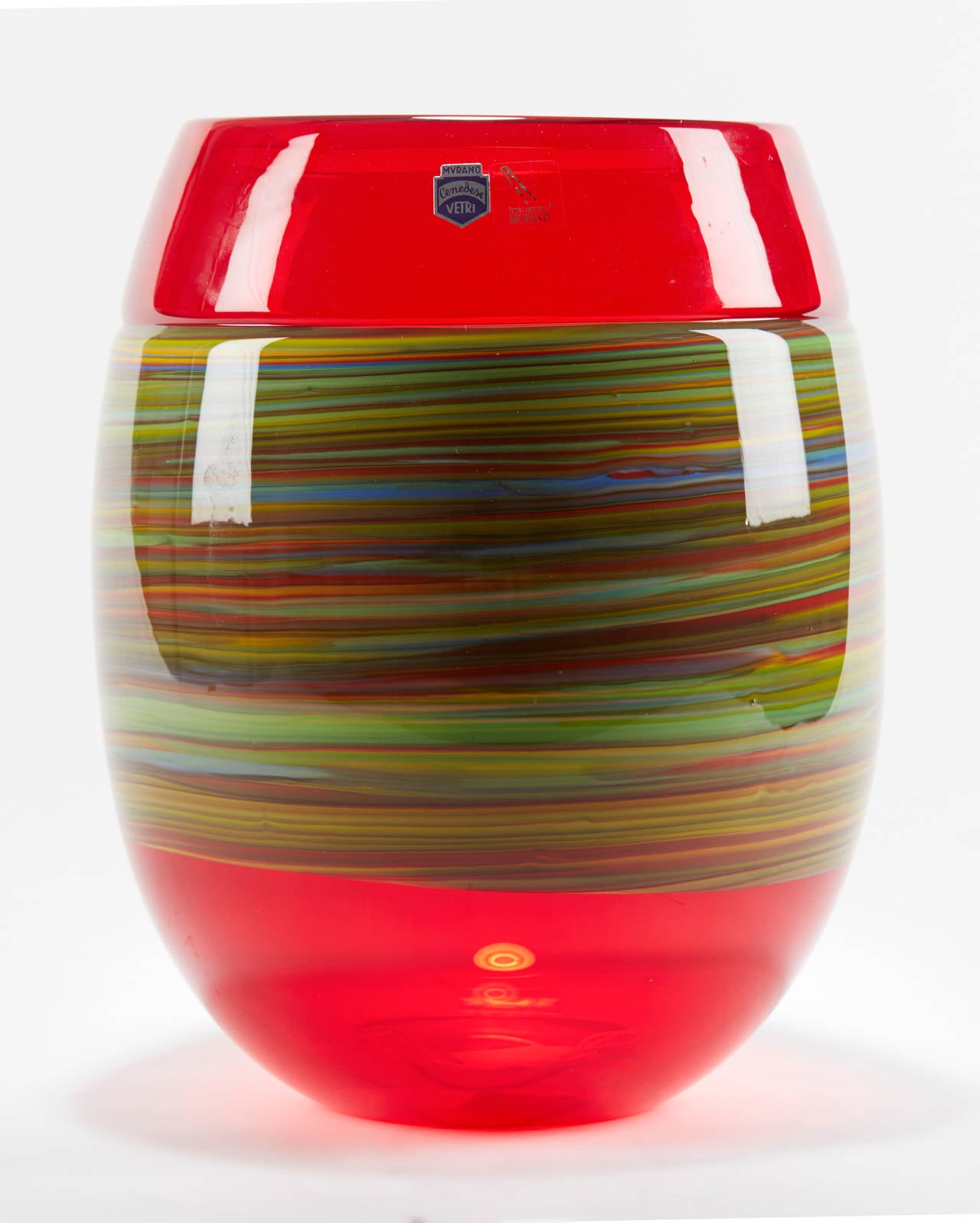 Murano handblown art glass vase by Gino Cenedese with clear red glass body with an opaque coloured glass swirl design applied around the middle of the vase. This heavily made vase has flat polished and signed base. 

Gino Cendese is one of the