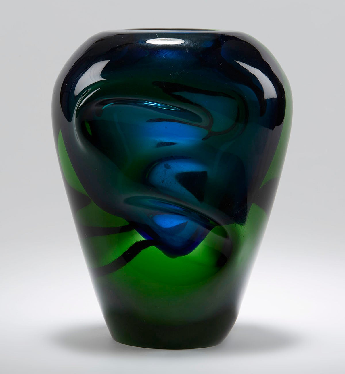 Czech Sommerso art glass vase designed by Jindrich Beraneck for Skrdlovice glass with a blue glass inner vessel cased in heavy green glass with moulded thumb print designs to either side of the body and with a narrow oval shaped opening to the top