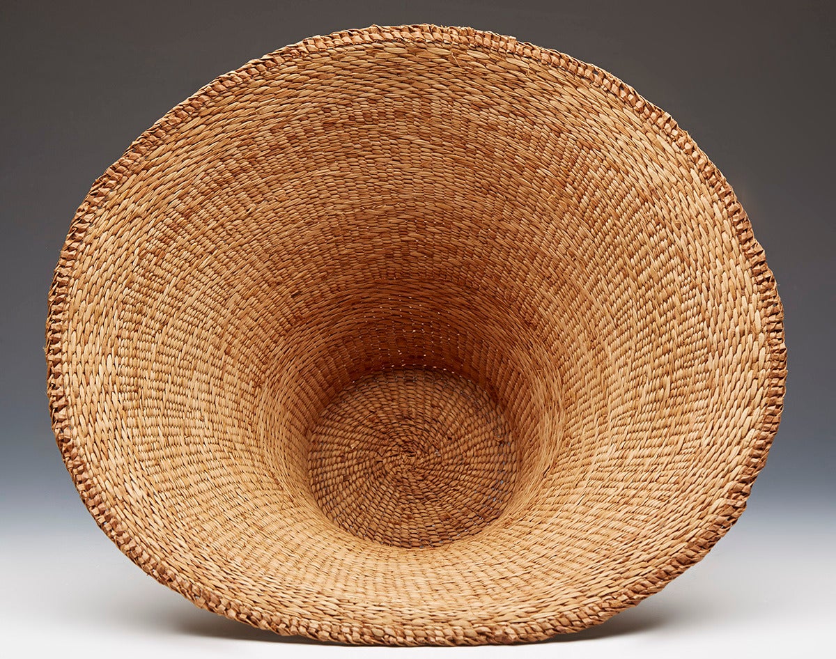 Originating from a private collection of Northwest Native American and related art is this fine Haida hand woven red cedar bark hat by Christine Carty. The bowl shaped flat top basket woven hat is not marked.

Provenance: acquired directly from