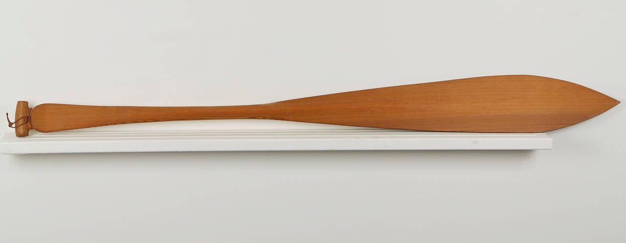 Originating from a private collection of Northwest Native American and related art is this fine unique Haida hand carved red cedar wood oar hand painted with a bird of prey by Giitsxaa (Ron Wilson). The oar is cut and hand carved with a raised ridge