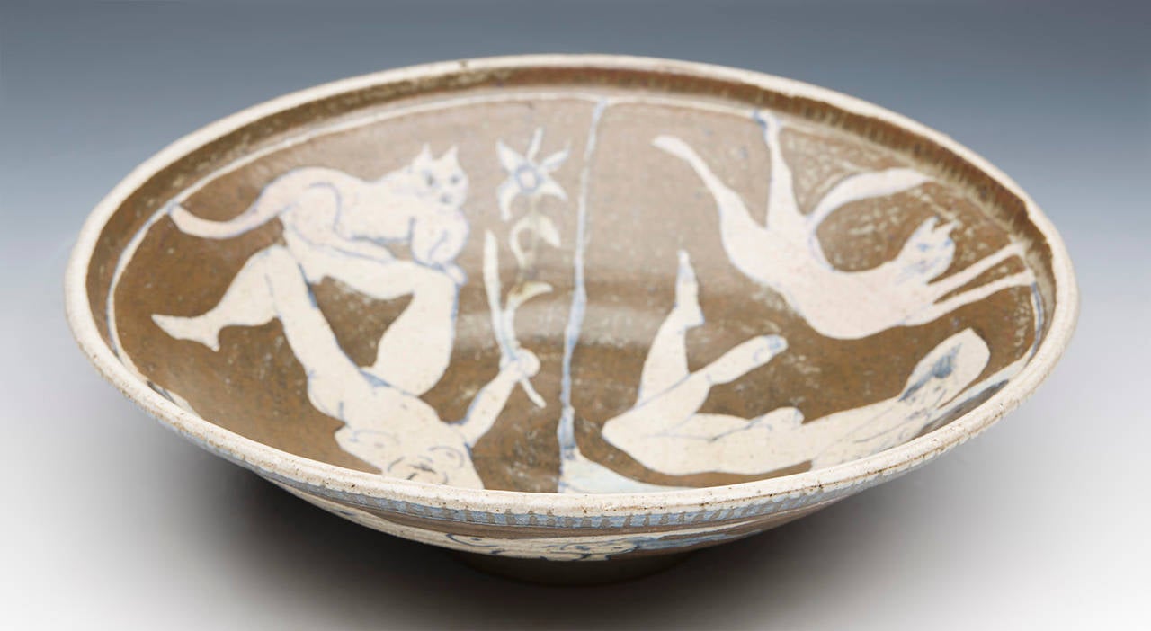 A fine vintage studio pottery bowl hand decorated with female nudes and cats in muted colours on a brown ground. The bowl by Eric James Mellon (1925-2014) is also painted around the underside with similar designs and is signed around the inner foot