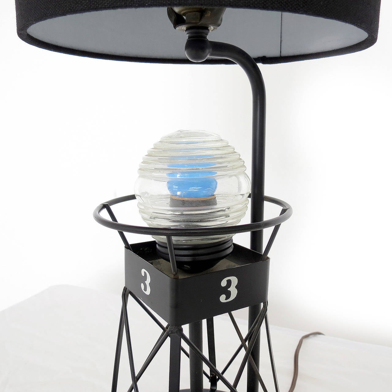 Nautical and whimsical, this lamp lights up blue at the top of the buoy and also has a regular bulb (switched separately). Comes with the black shade.