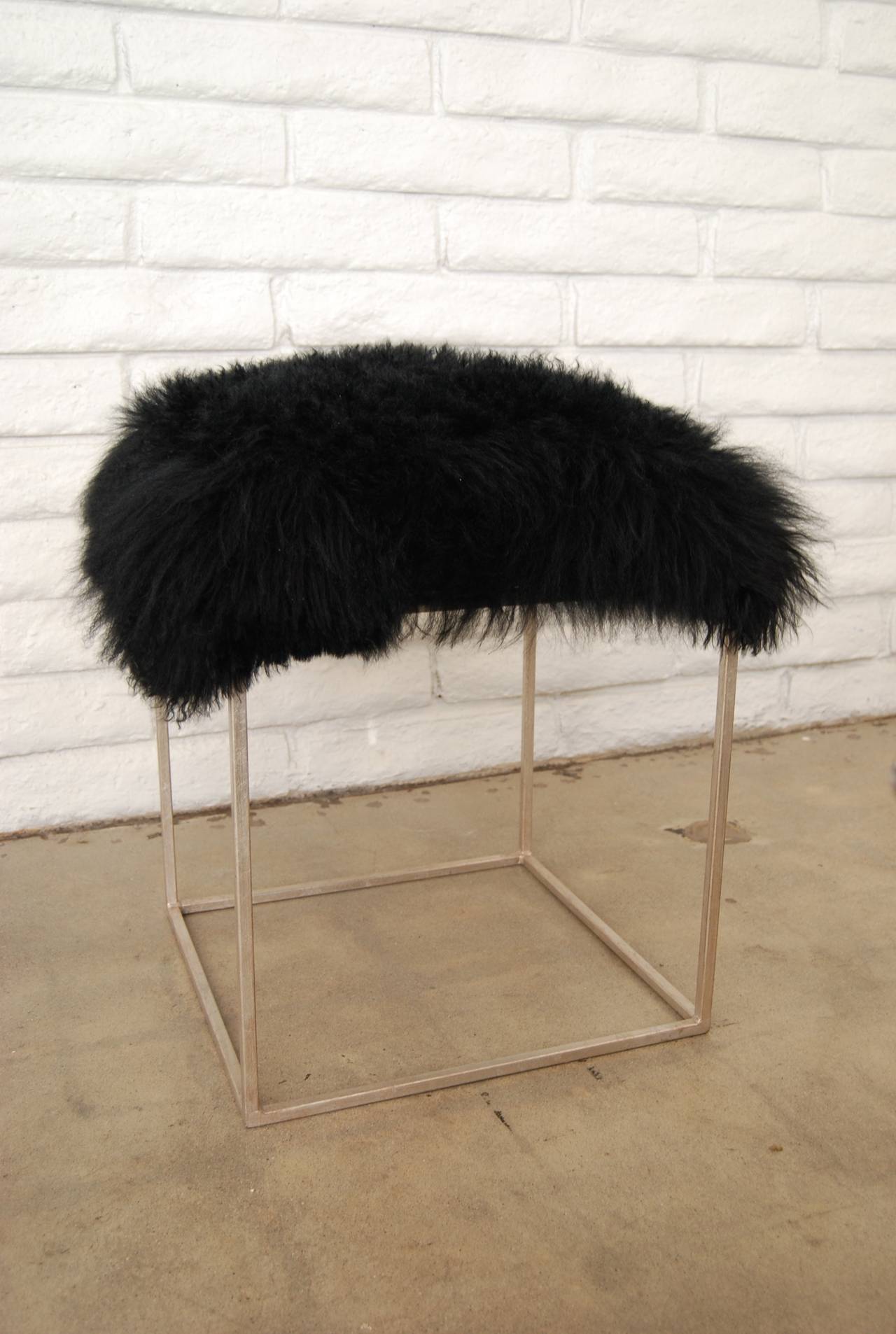 Towne original - Black Mongolian lamb fur cushion on a silver leaf metal base. The base itself is 18