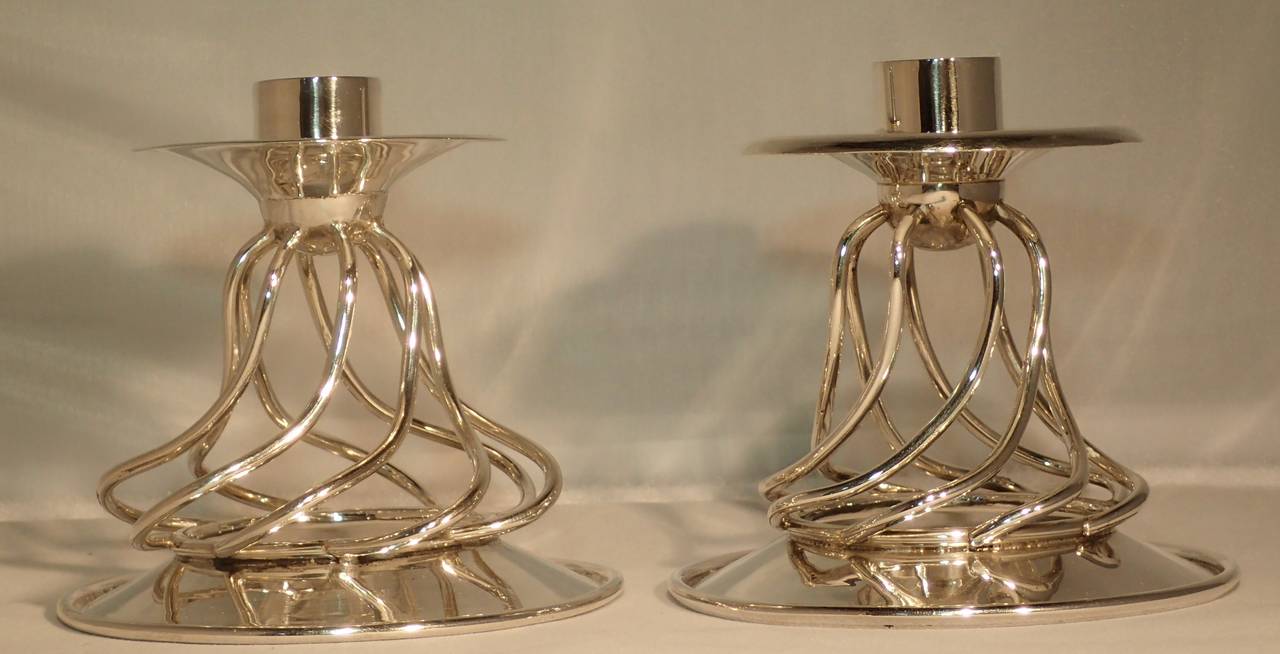 Pair of beautifully articulate silver candlesticks by William Spratling. Formed on circular disk base with a spiral twisted wire “Los Serpentinas” motif, culminating in a half sphere with a second disk bowl and candle cup.

This wonderful pair of