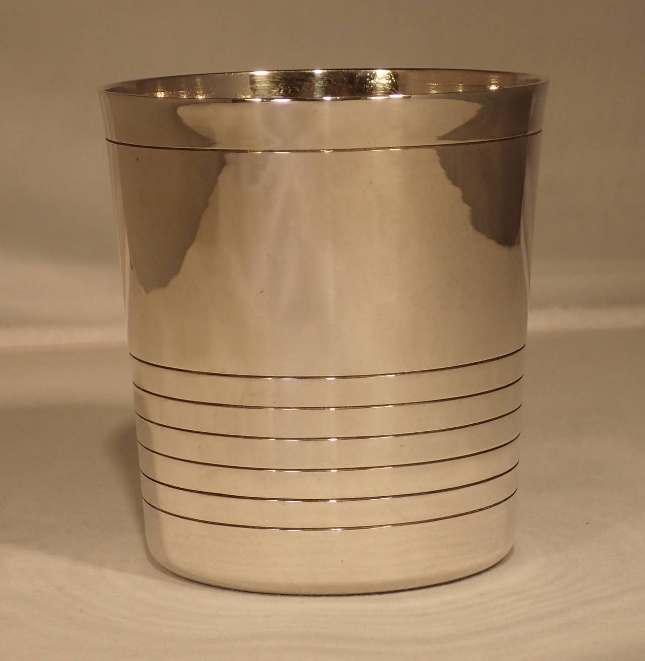 A beautifully simple and solid silver cocktail tumbler by William Spratling. Formed as a slightly tapered conical cup etched with modern line motif around top lip and bottom half of body
Stamp: marked with the William Spratling hallmark of WS-BB.
