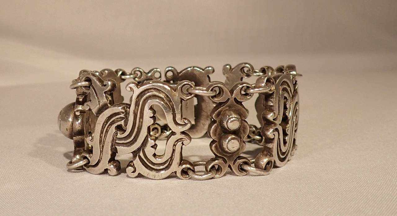 A beautifully rustic and tribal style silver, “vindobonensis” pre-columbian linear motif bracelet by William Spratling. Formed by links made of woven criss crossing flowing lines and links of etched half spheres joined together to form an intricate