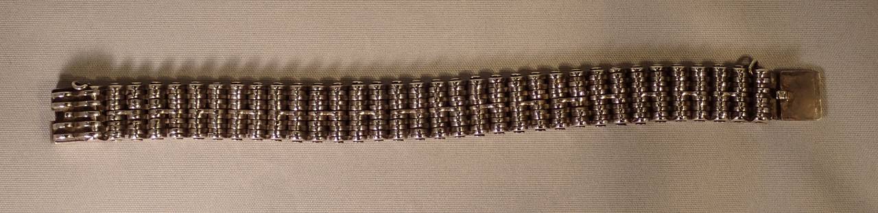A magnificent and tightly layered silver bicycle chain style link and pin bracelet with square tension resistance clasp by William Spratling.
Stamp: marked with the William Spratling hallmark WS-BB. 1962-64. Silver mark. Variation of WS-X—in