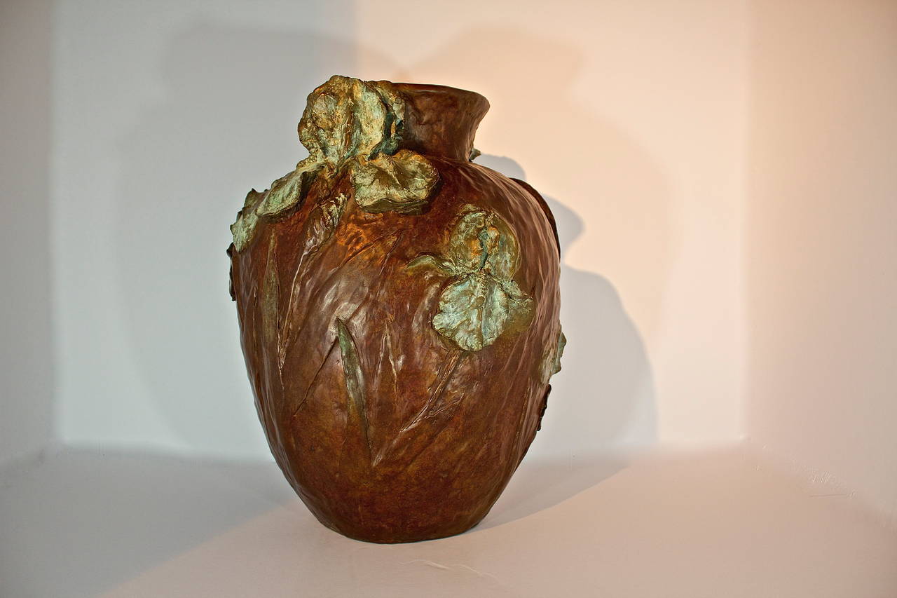 An exceptional bronze vessel by Joe Anna Arnett.
This rare piece of work is a number 1 in a series of 35. A beautiful vase of textured bronze enveloped with clusters verdigris patina iris.
