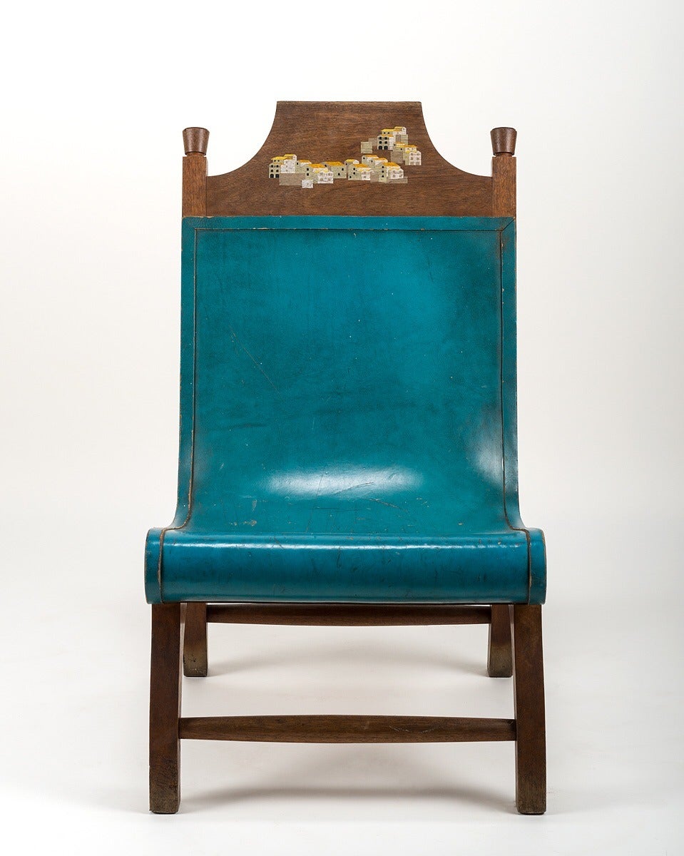 Handcrafted and assembled hacienda chair featuring Hidalgo's blue-dyed leather and iconic stamp of a Mexican scene painted at the crown of the chair. Hidalgo is a renowned illustrator and is displayed in a museum dedicated to his work at the