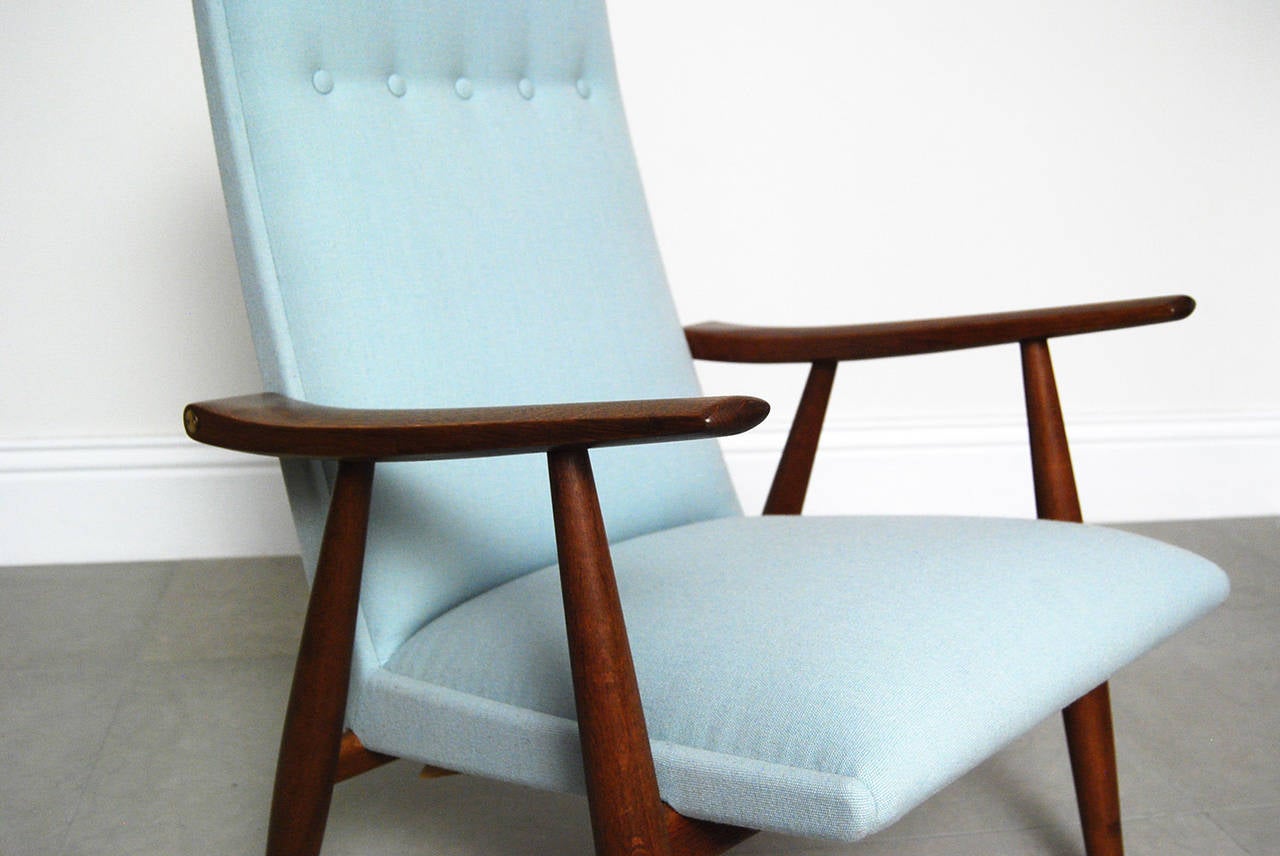 High back version of Hans Wegner's GE-260 chair for GETAMA, Denmark, circa 1960. This example comes in oak with exposed brass joints and new pale mint green wool fabric from Bute.