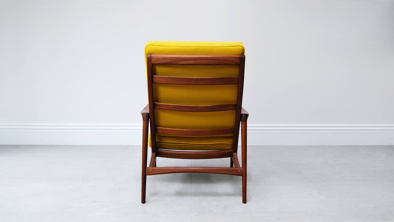 High-backed armchair from British manufacturer Guy Rogers in Afromosia teak, circa 1960. Reupholstered in mustard yellow Hallingdal fabric by Kvadrat.