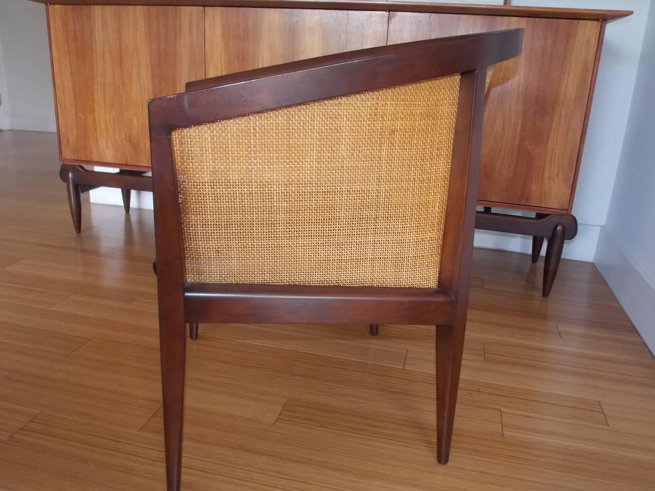 An elegant occasional chair.
Made of solid walnut frame with original cane and reupholstered chic black leather seat.
The cane has one or two small breaks, nothing major.
It's in good used condition, sturdy and stout.