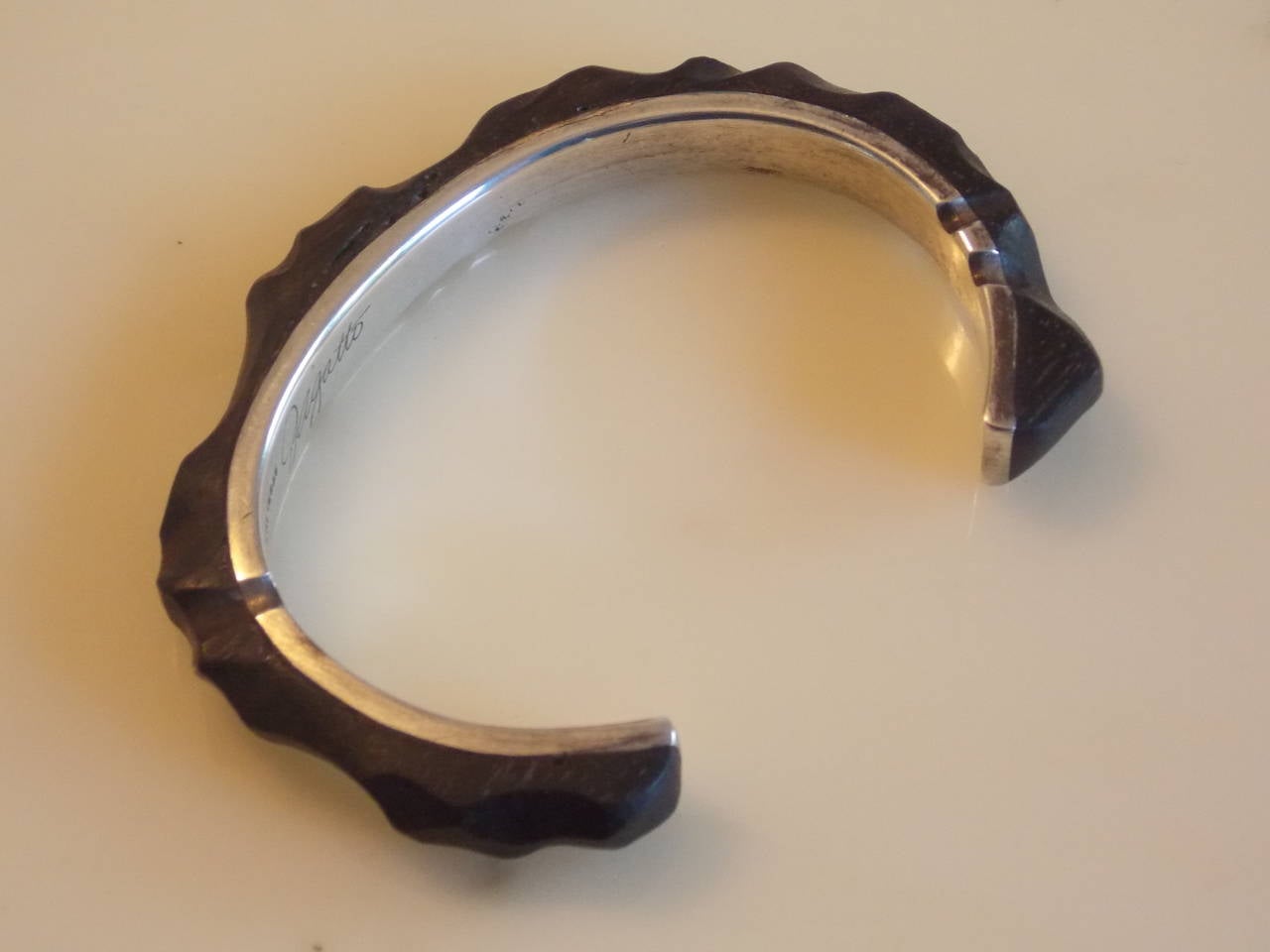 1934-2013.
This bracelet was acquired directly from Mr. Gatto roughly about eight years ago at a jewelry show at the Santa Monica Civic Center in California.
It's made of carved ebony wood with sterling silver.
Mr. Gatto said that the wood