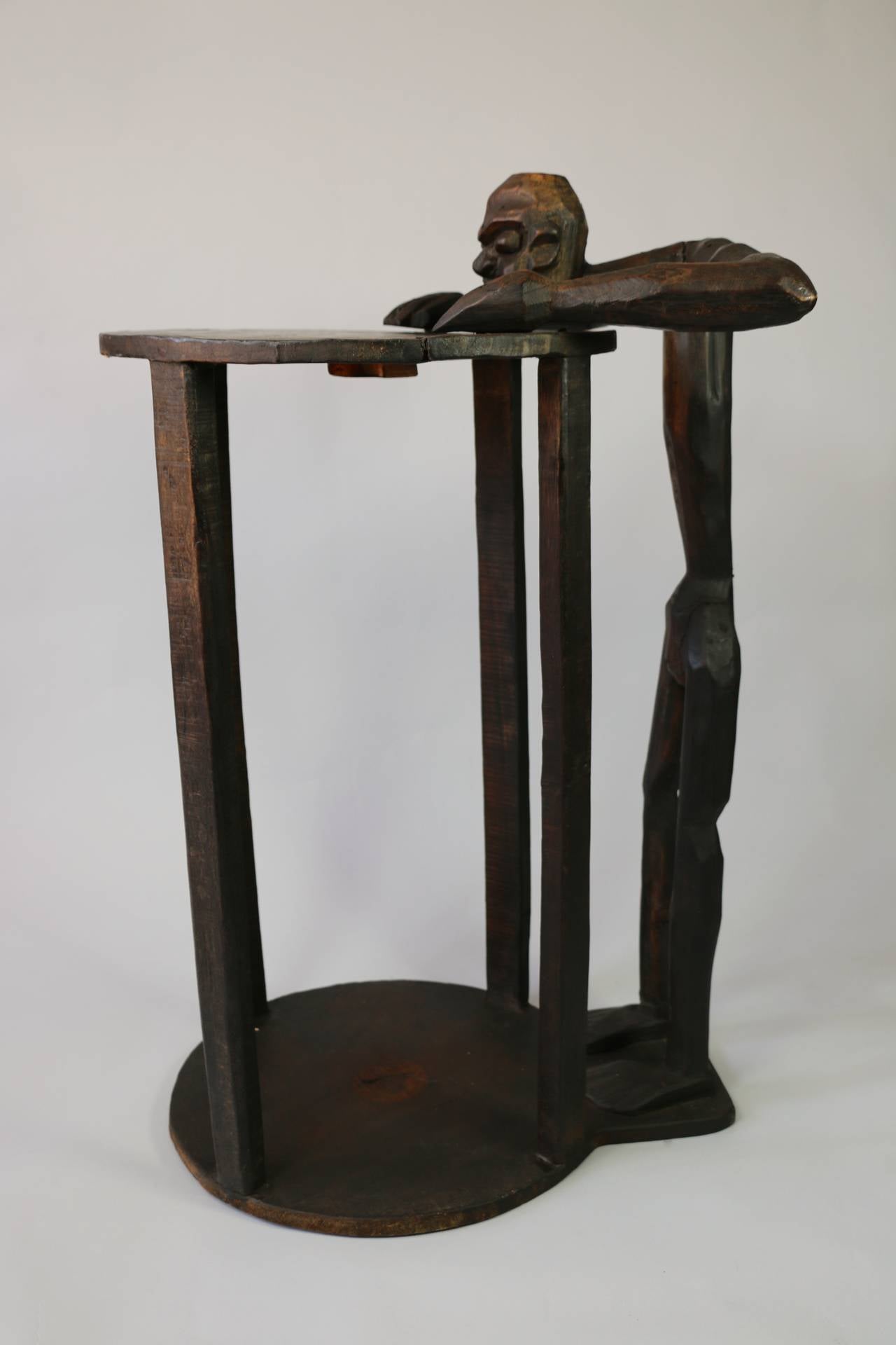1950s circular pedestal table made of dark wood.