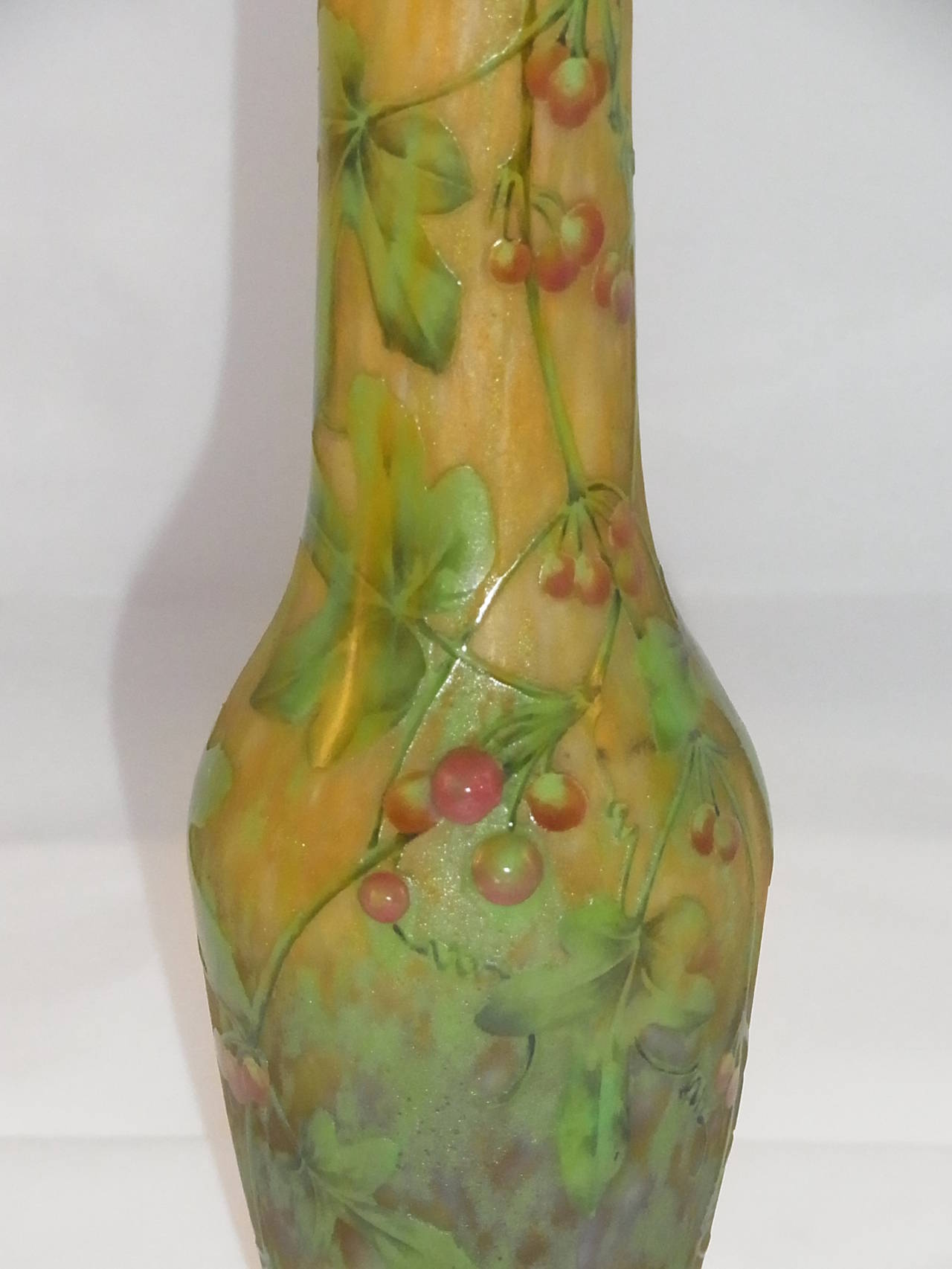 A Daum Bryony cameo glass, enameled and applied vase.
Cased, overlaid and acid-etched with trailing leaves and tendrils, with painted details and applied red glass and painted berries.
Signed in cameo Daum Nancy with the Cross of