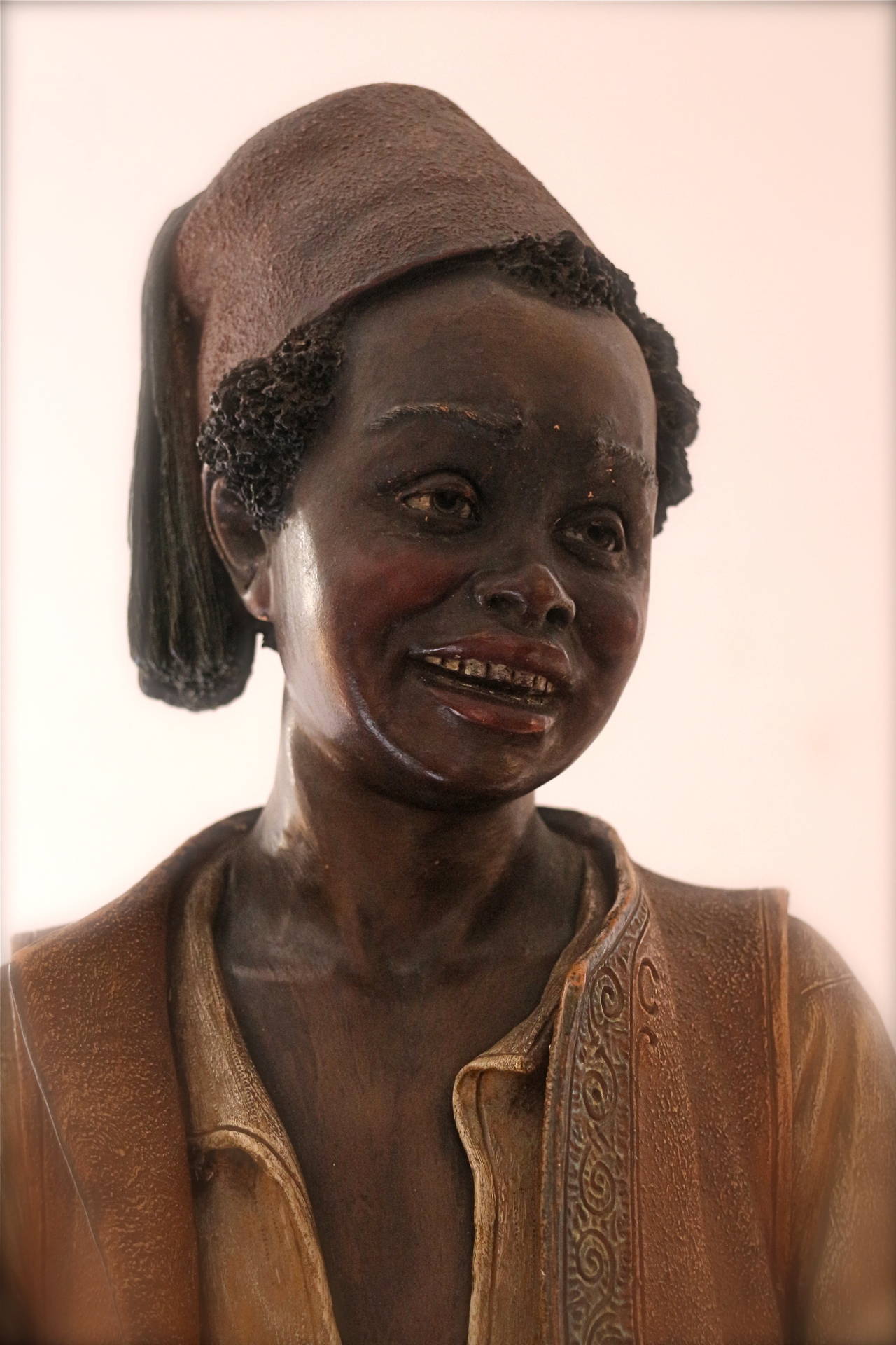Black person holding a tray . Terra cotta , by the maker of BB 