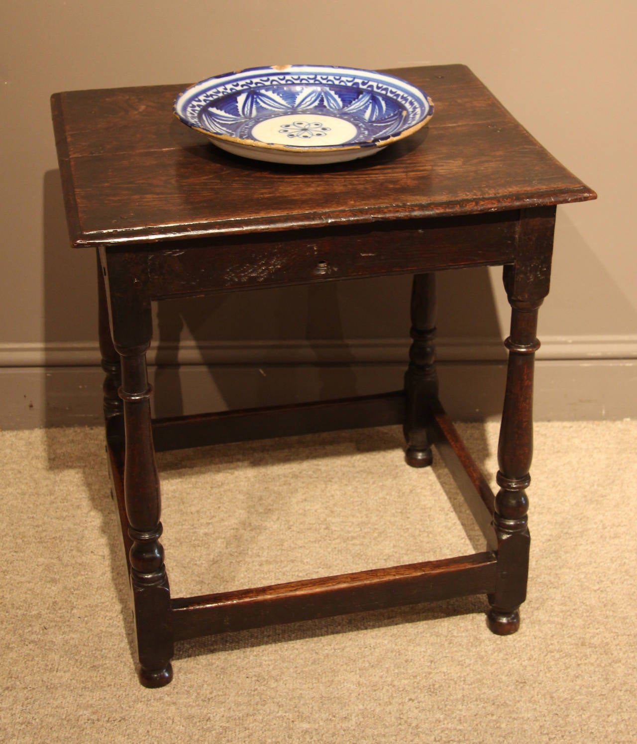 A rare Queen Anne oak centre table of exceptional small size and all original condition, lovely patina and colour. Raised on baluster turnings tied by stretchers, circa 1710. 

All of the items that we advertise for sale have been as accurately