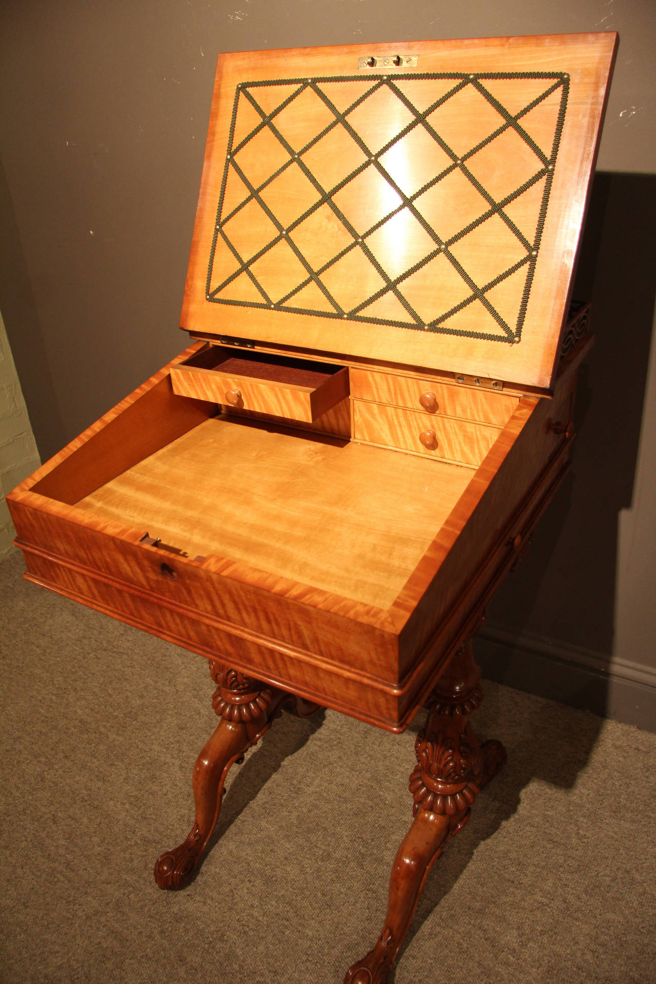 A fine late Regency period satinwood writing/davenport. This piece is highly figured with a secret drawer and side slide on well carved legs. This has a superb original pierce gallery and is highly recommended, circa 1825. 

Shown with a mini
