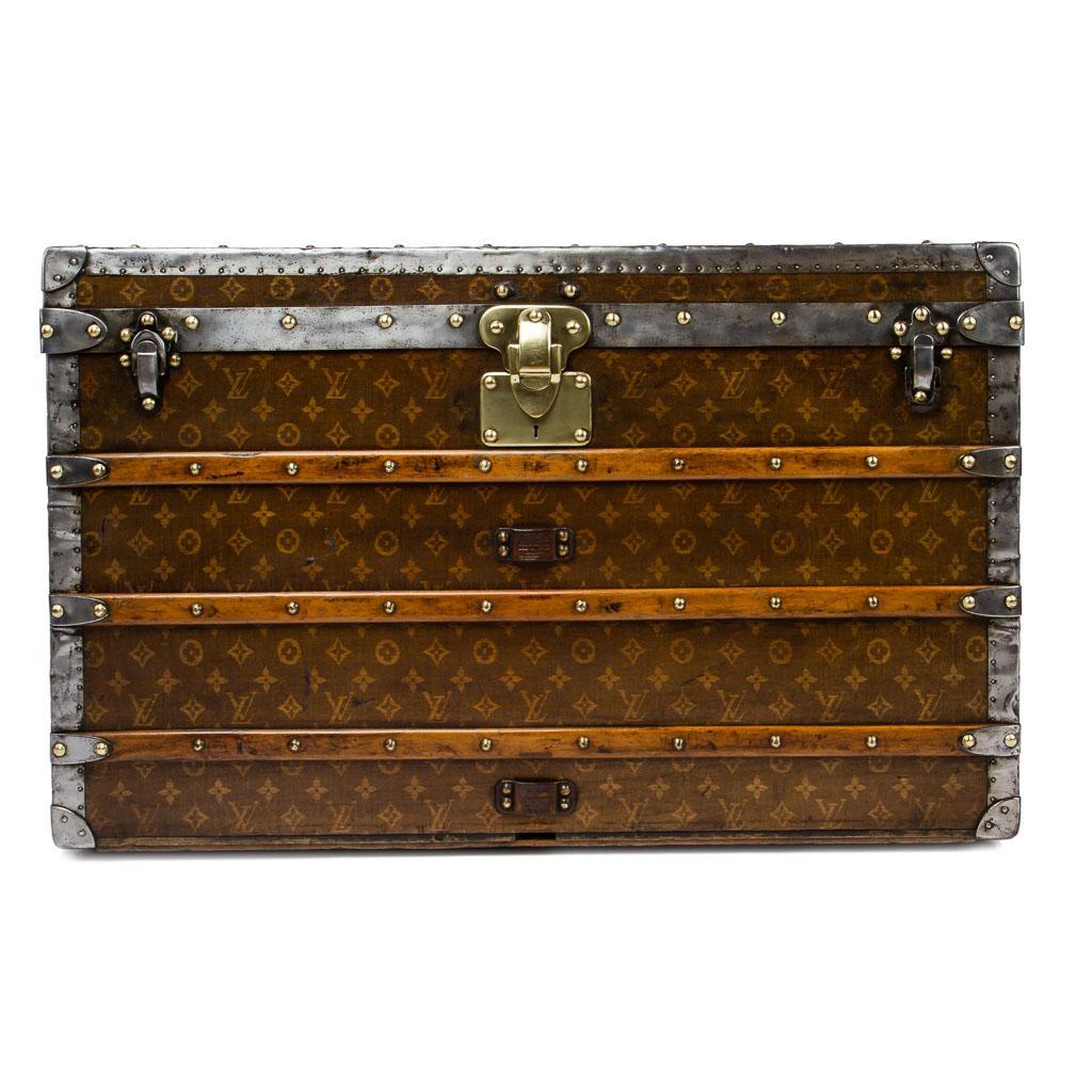 Antique late 19th century genuine and superb Louis Vuitton steamer trunk, very large size, rare tisse' monogram canvas, polished metal bound, reinforced with wooden laths, with wheels to the base and metal handles to either end, interior lined with