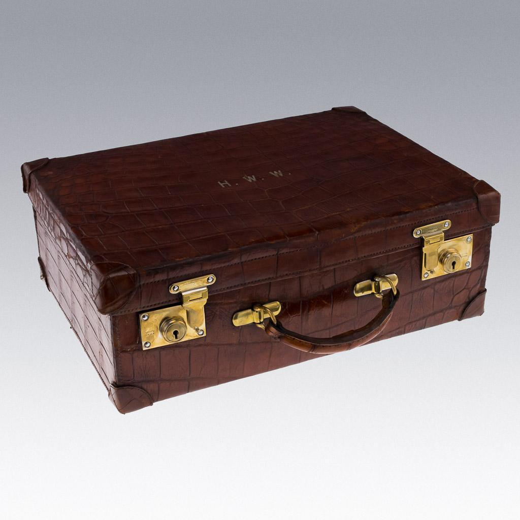 Antique 20th Century Edwardian brown crocodile leather suitcase fitted as a watch case, two fitted levels with compartments for storing watches. The antique case is very stylish and decorative, perfect for a collector of fine watches or for a watch