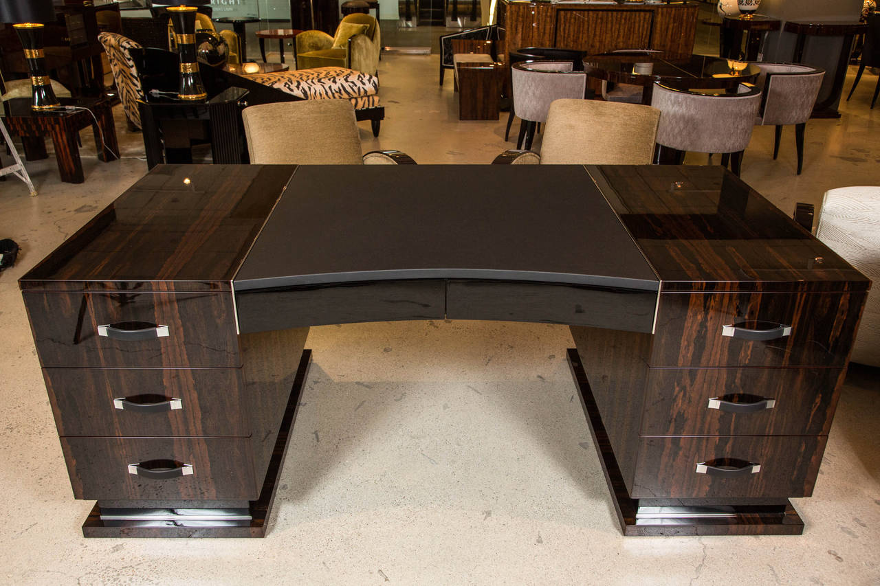 Imposing Art Deco style executive desk by German fine furniture maker Cygal Art Deco. This handcrafted desk is displaying the rich ziricote veneer with its cloud like pattern, off-set by black high gloss and stainless steel details. The hardware,