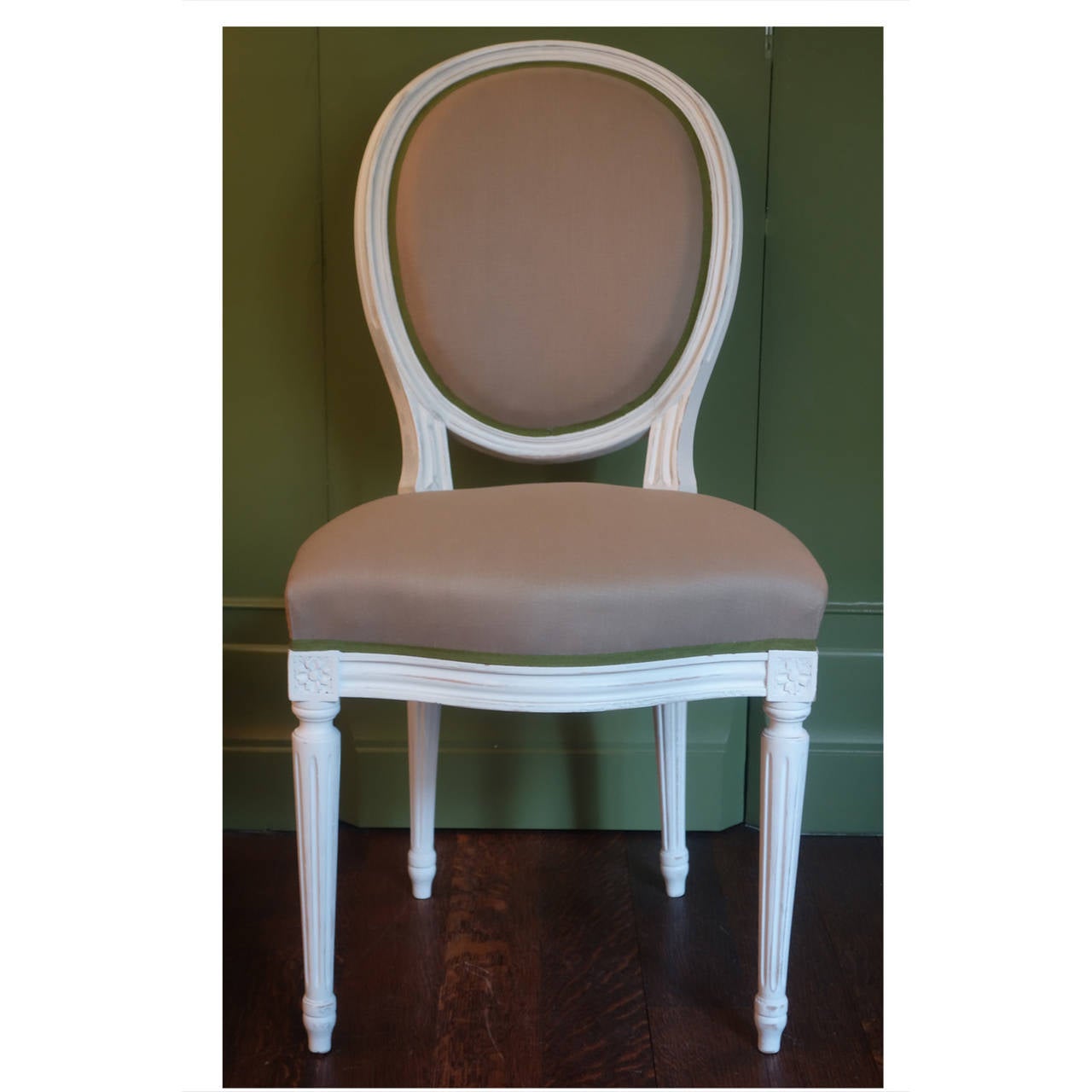 Set of six Louis XVI style dining chairs, circa 1900.  Newly upholstered in oyster and celery linen with contrasting grosgrain trim.  Paint has been refreshed.