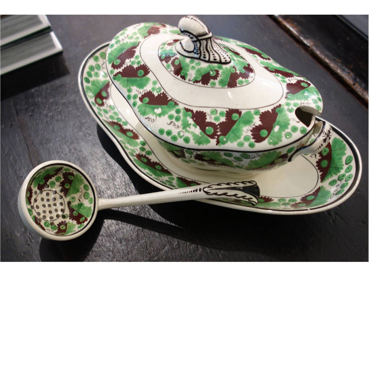 Assembled set of mid-19th century Spode creamware, green and brown oak leaf and acorn pattern.  Set includes:

complete covered gravy boat with pierced ladle 10