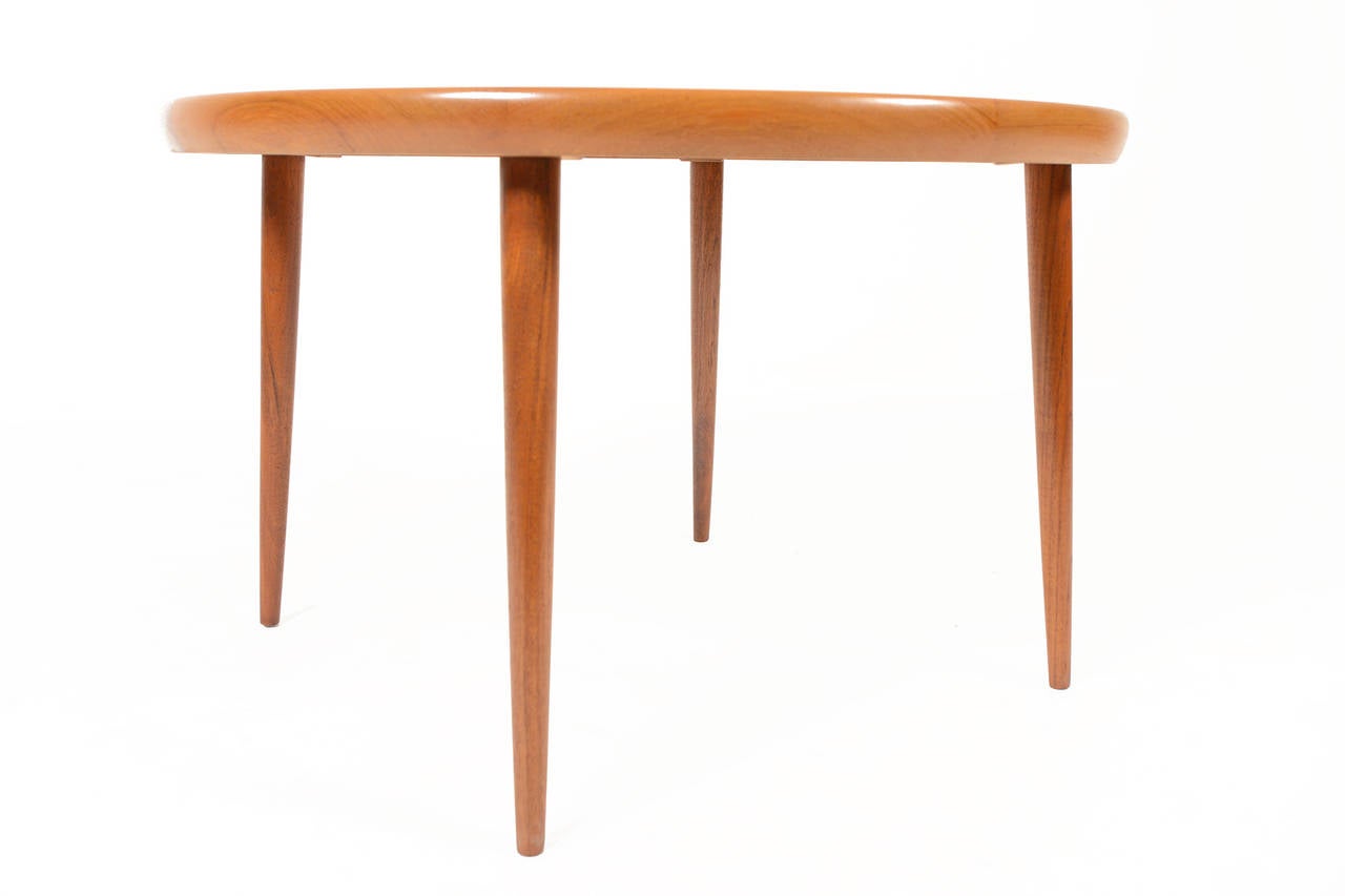 Danish modern mid century circular coffee table in teak by Spottrup Møbelfabrik. Starburst veneer inlays and subtly canted legs make this piece the perfect coffee table or side table for any modern home. Recently refinished and in excellent