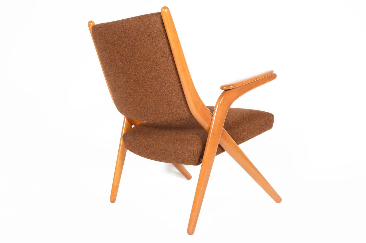 This uniquely proportioned Danish modern scissor chair is perfect for any room looking for a comfortable lounge chair without an imposing footprint. The sculpted teak frame has been completely refurbished. Recently upholstered in Danish Kvadrat