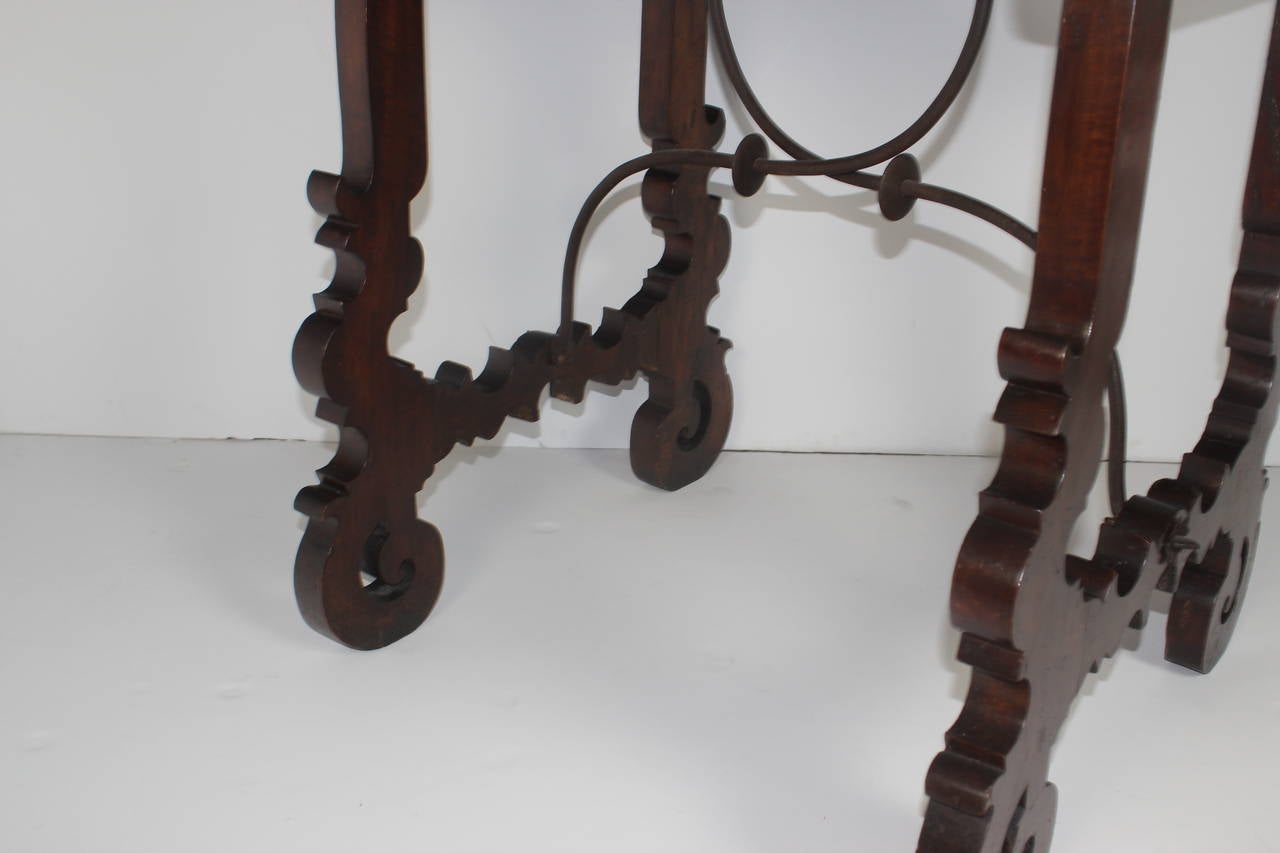 A beautiful Spanish writing table with rectangular top. Yok-form legs joined by iron stretcher.