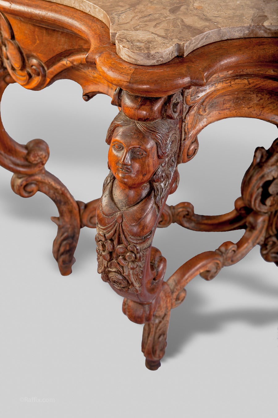 Wonderful quality 19th-century Italian hand-carved walnut console. Each corner has a detailed carving of a woman's face. The base has a baroque style carving.   The marble is later.